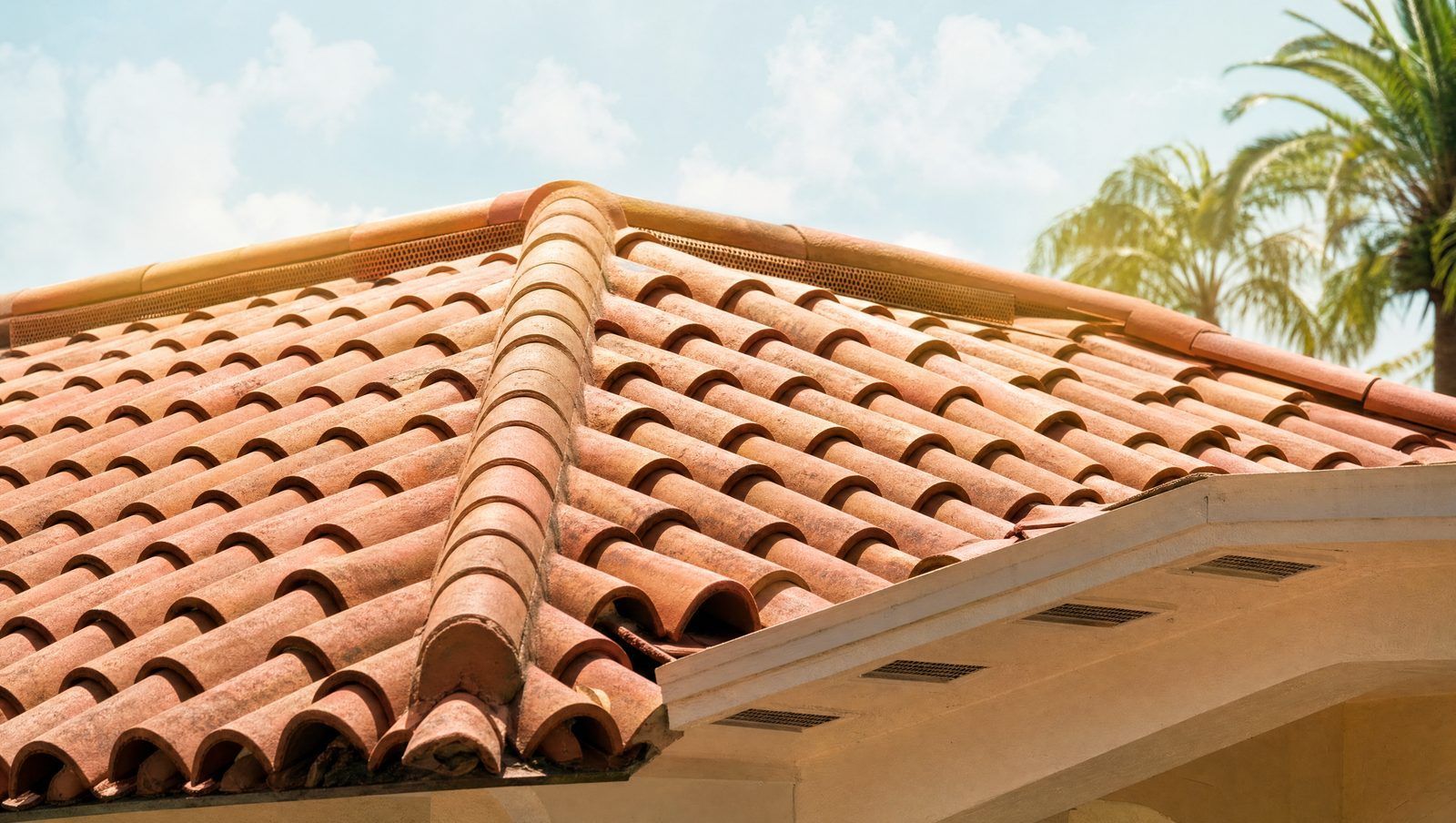 Sun-baked barrel tile roof in Boca Raton with ridge vents and soffit vents that keep the attic below