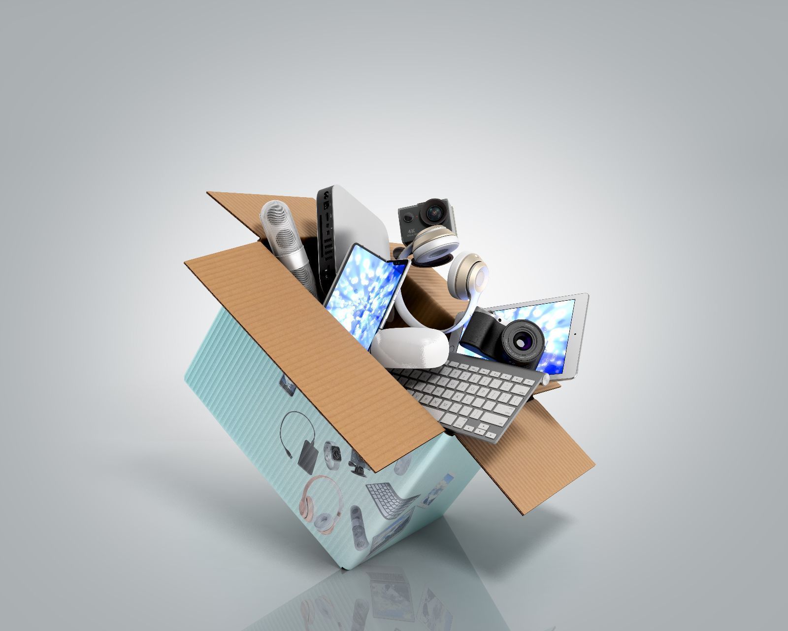 Una caja de cartón repleta de aparatos electrónicos, como cámaras, tabletas y auriculares, sobre un fondo gris.