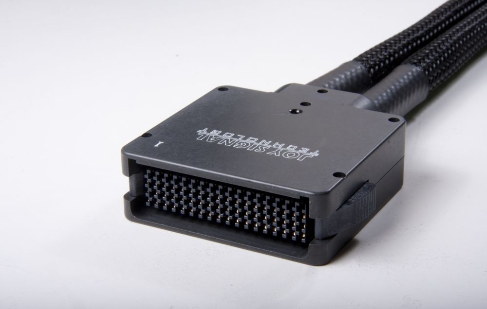 Black rectangular electrical connector with many pins, two cable bundles.