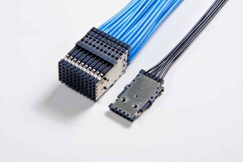 Two cable connectors with blue and black wires against a white background.