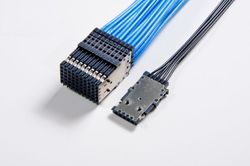 Two connectors with blue and black wires on a white surface.