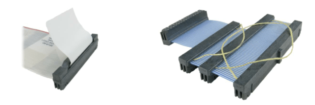 Two ribbon cable connectors. One is folded, the other is connected.