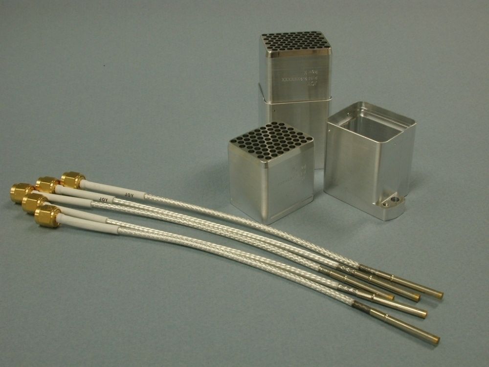 Aluminum heat exchangers and six white, flexible cables with gold connectors.