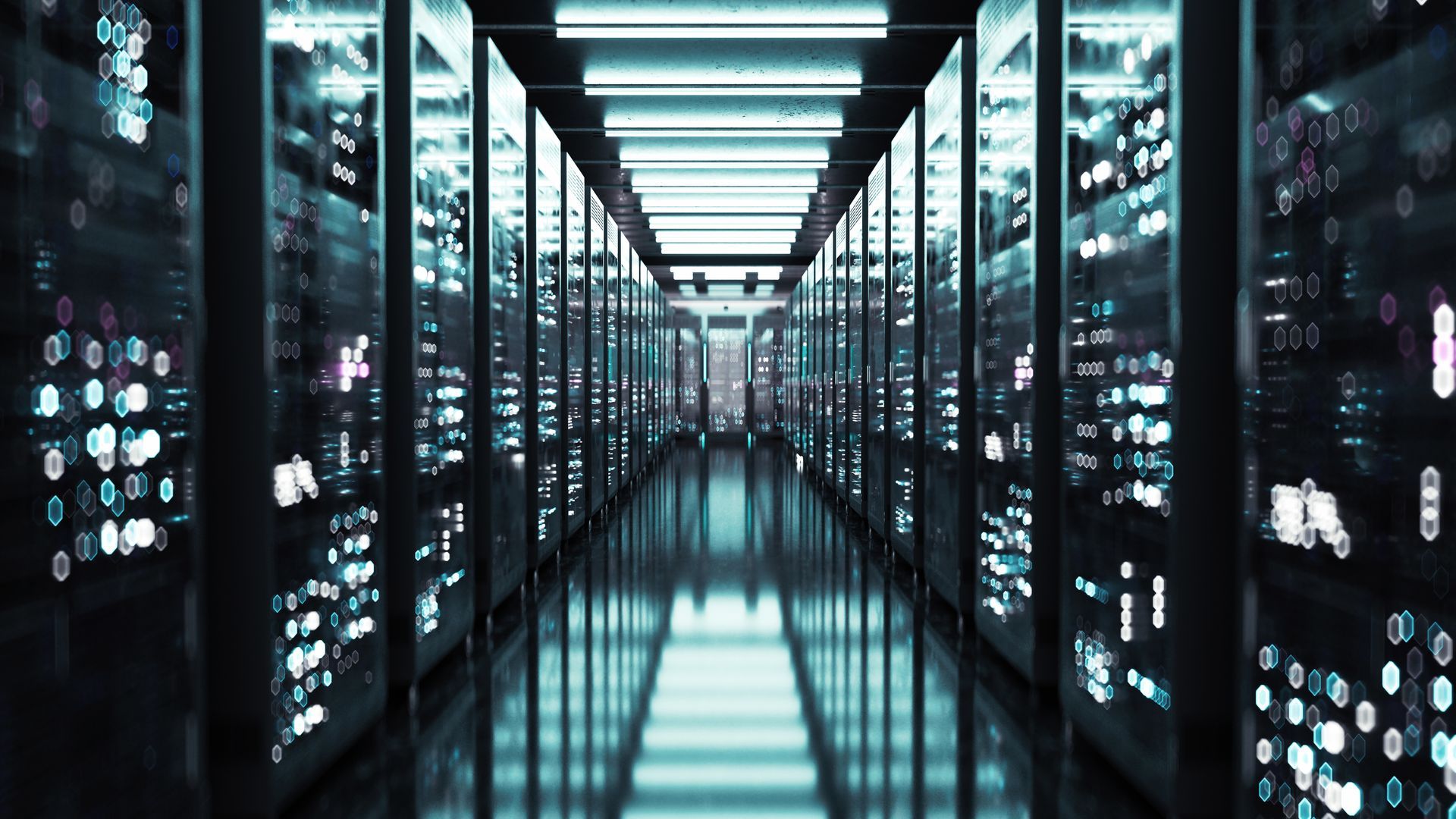 Data center hallway with rows of servers, illuminated in blue and white.