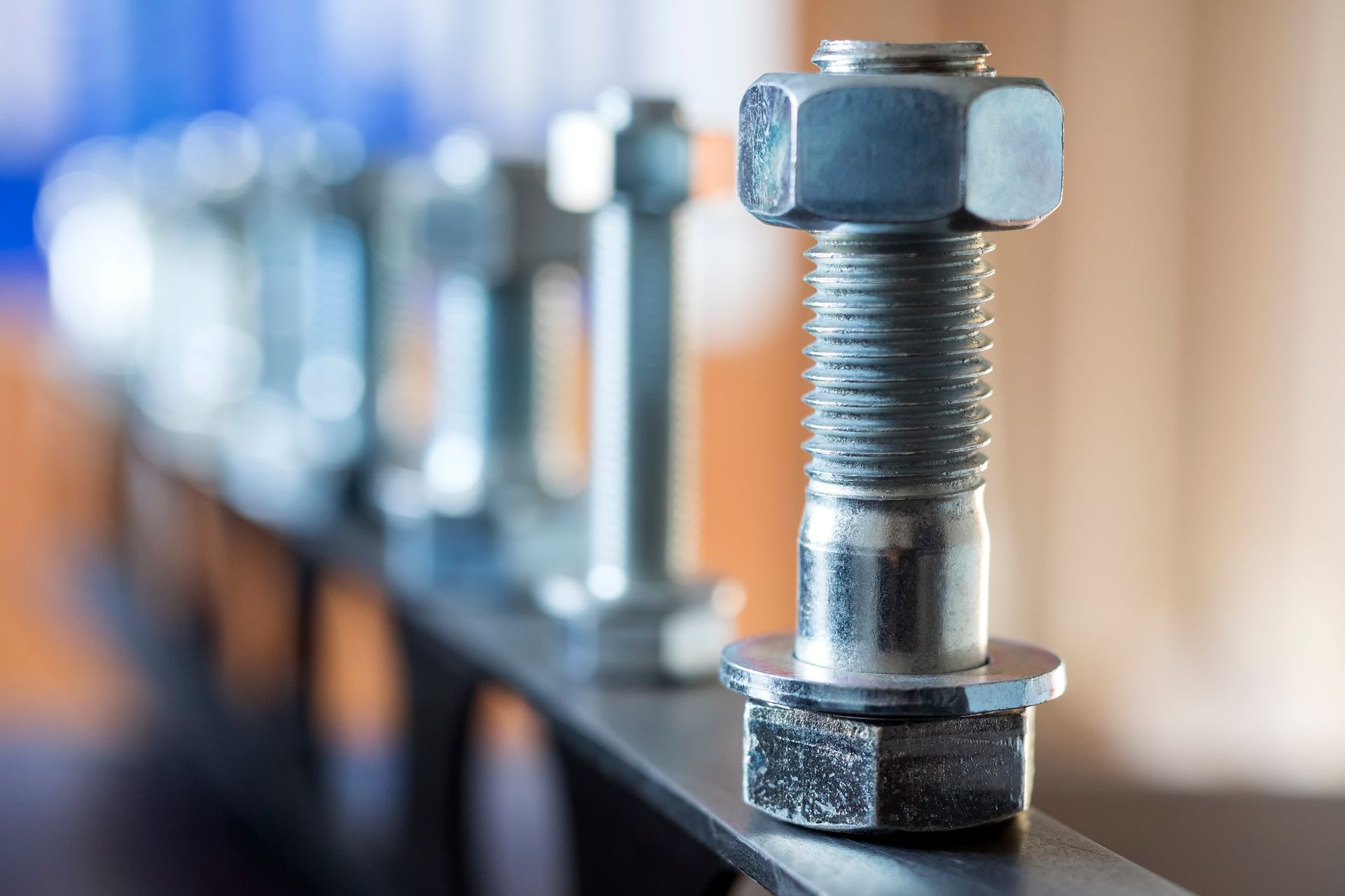 A close up of a bolt and nut on a metal surface.