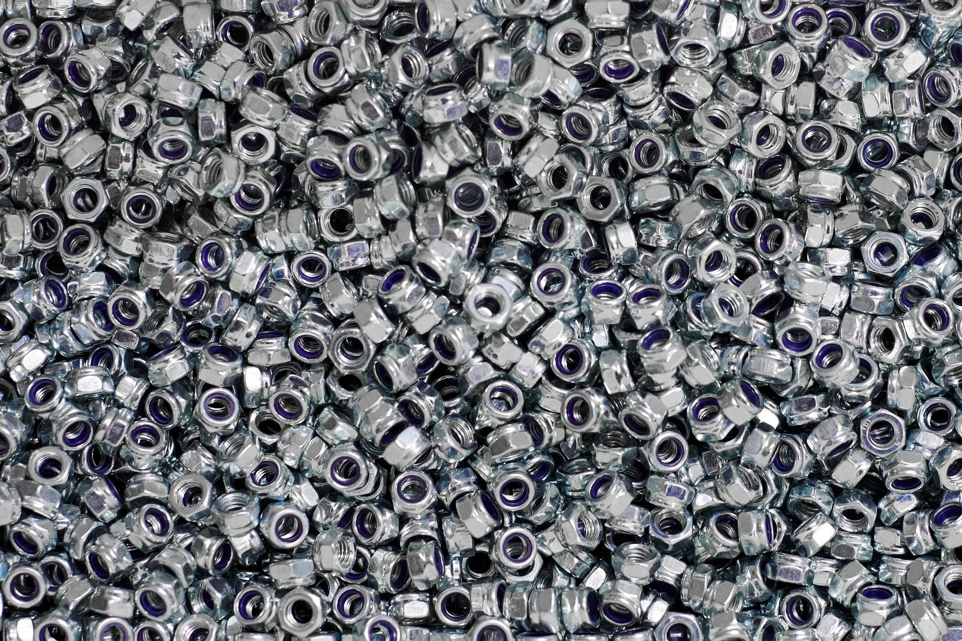 A pile of nuts and bolts on a table.