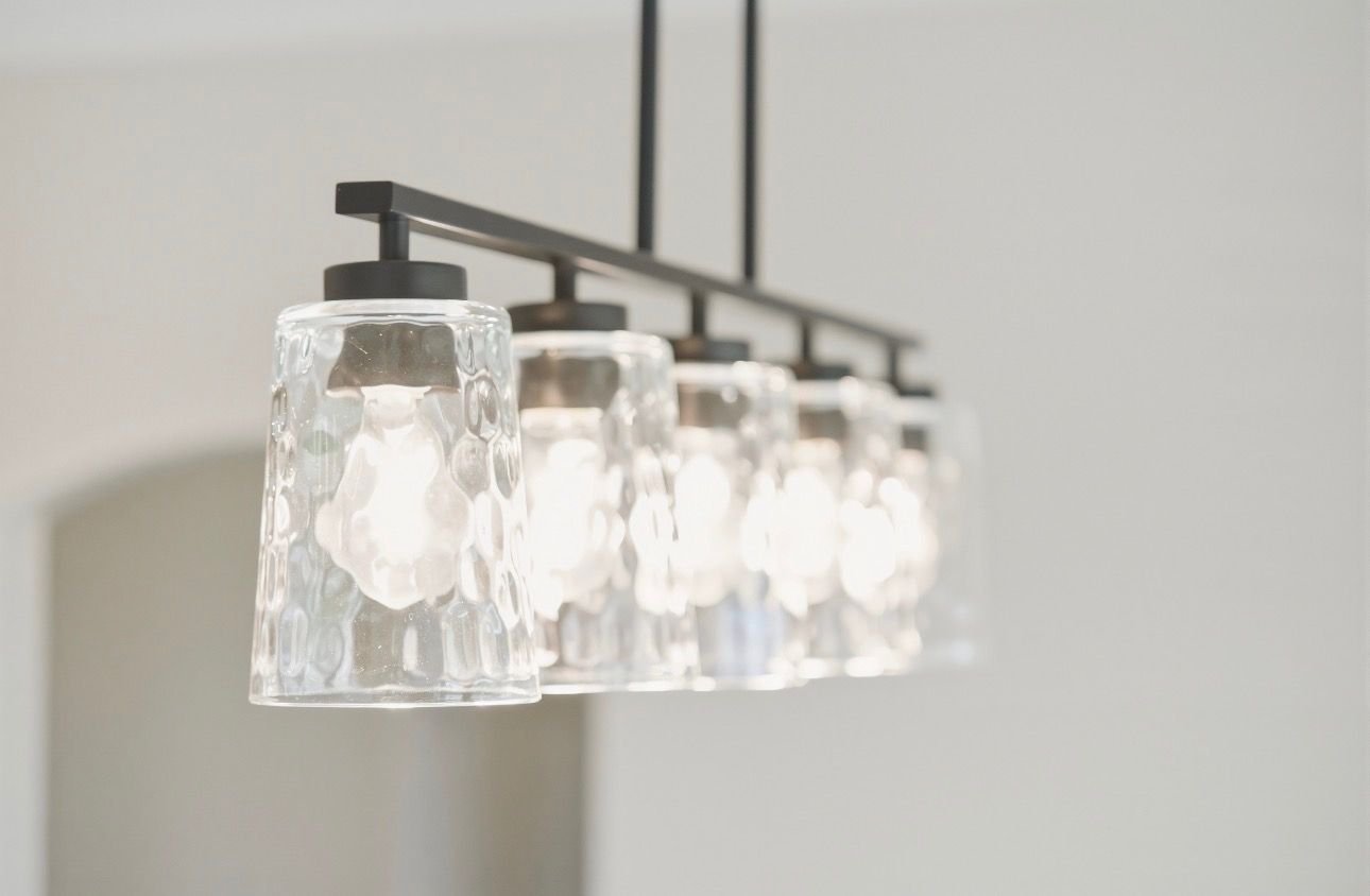 Modern black pendant light with frosted glass shades hanging indoors