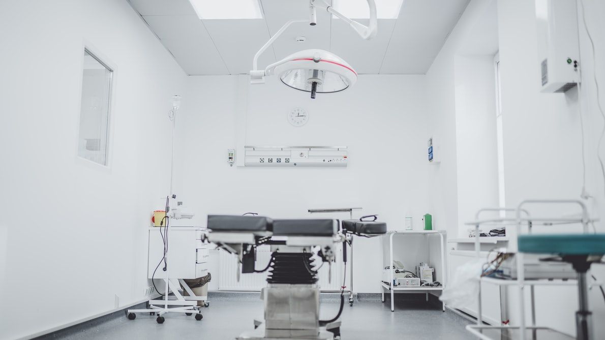 An empty operating room in a hospital with an operating table.