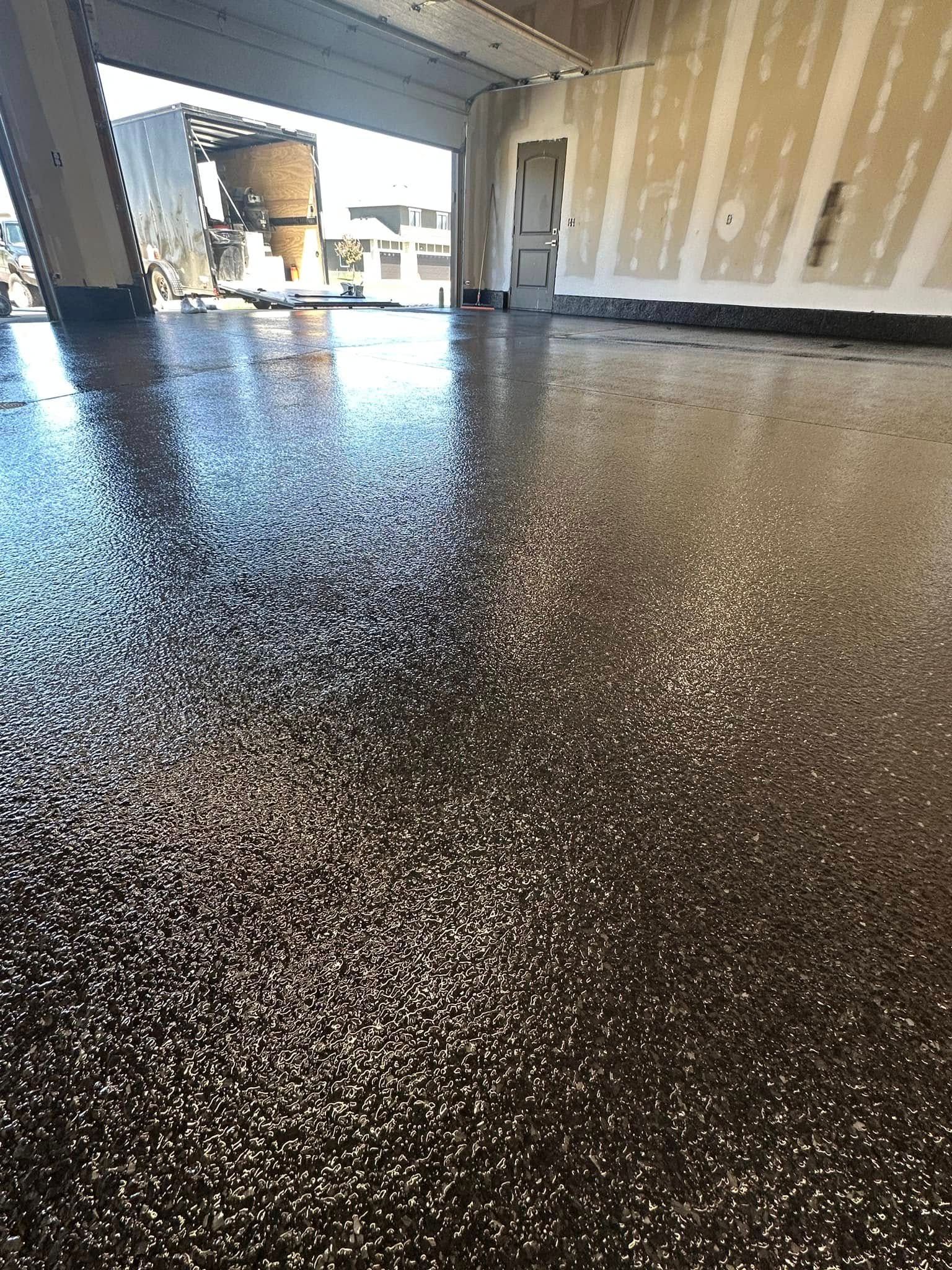 Shiny, speckled floor reflects light in an open room. Construction is visible.