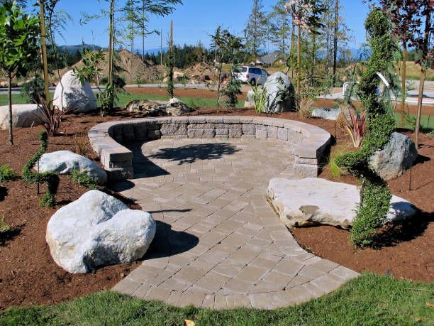 A stone walkway surrounded by rocks and trees in a park.