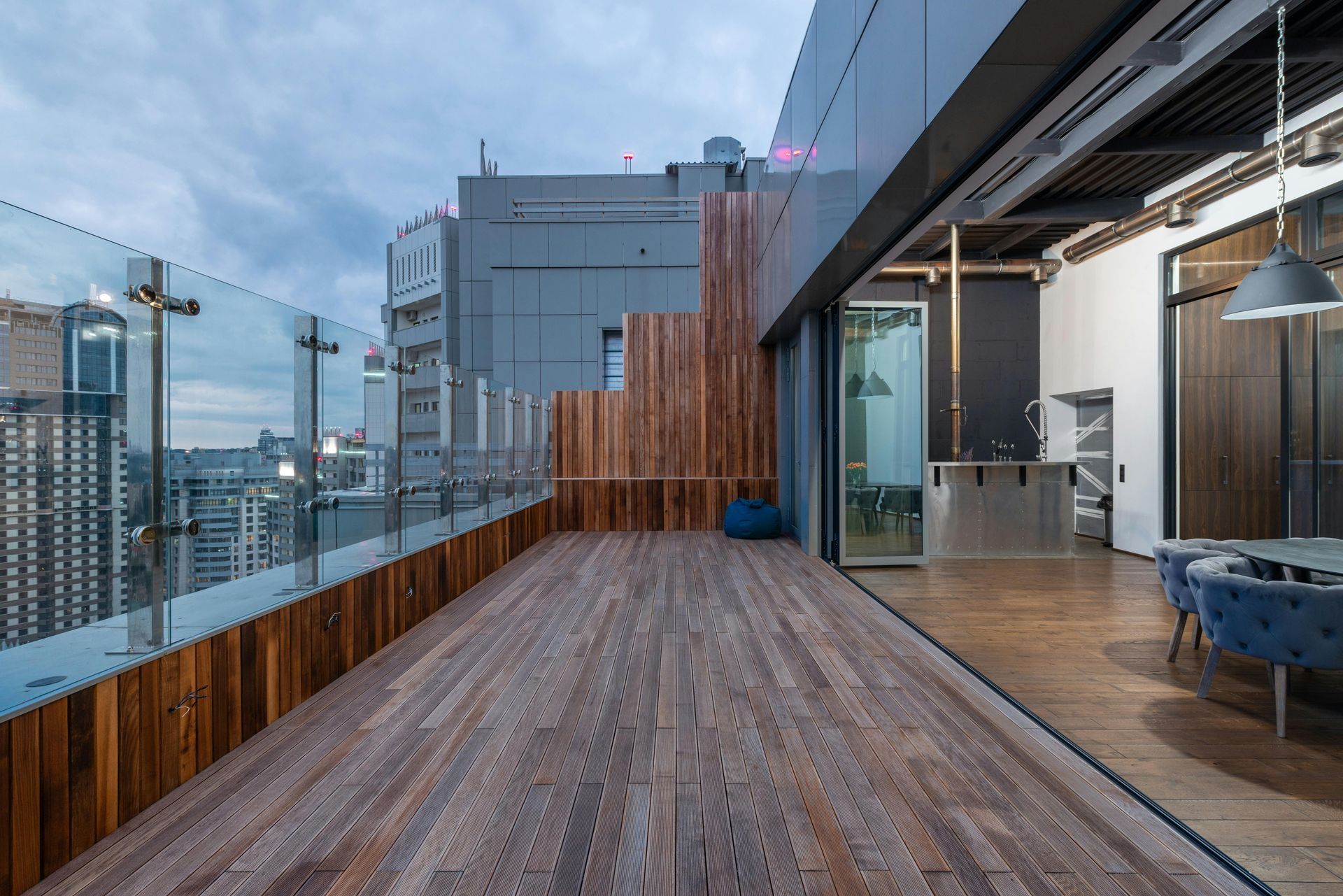 Premium hardwood flooring with rich brown grain patterns professionally installed on modern terrace