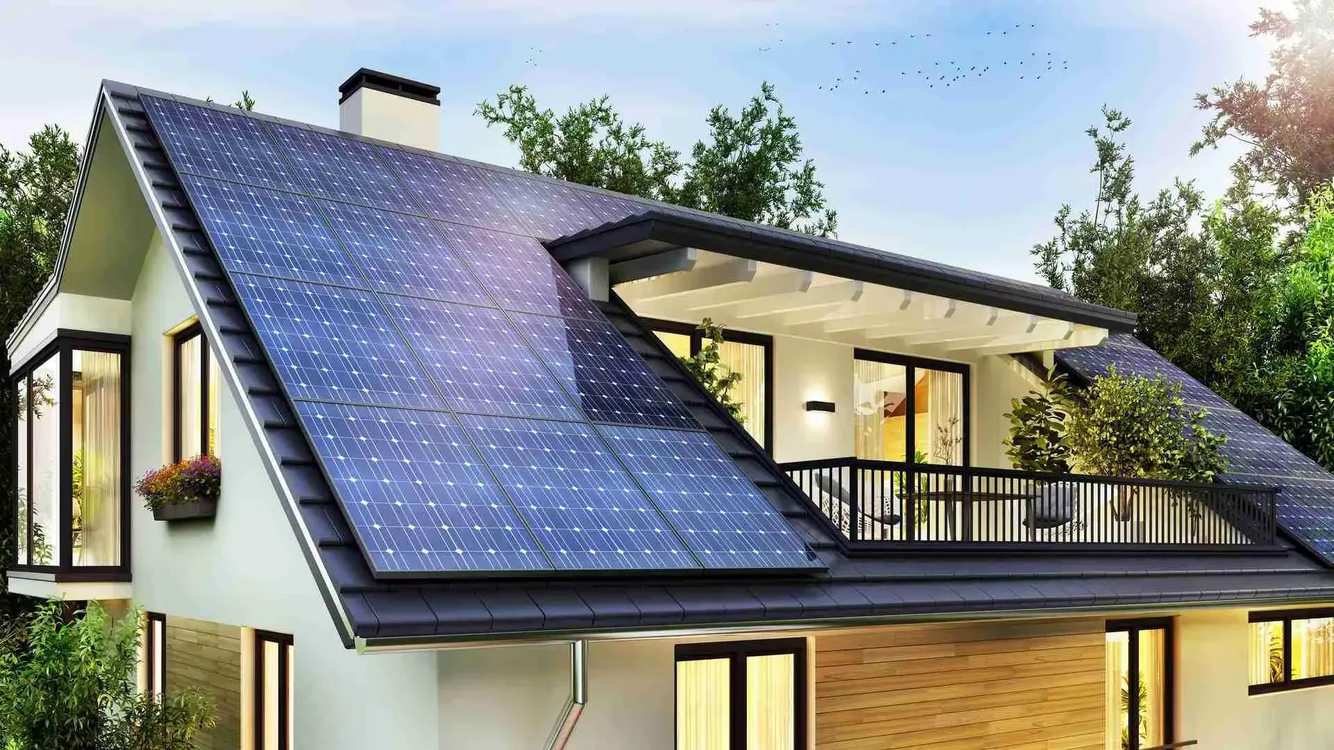 Modern house with large blue solar panels on the roof at dusk