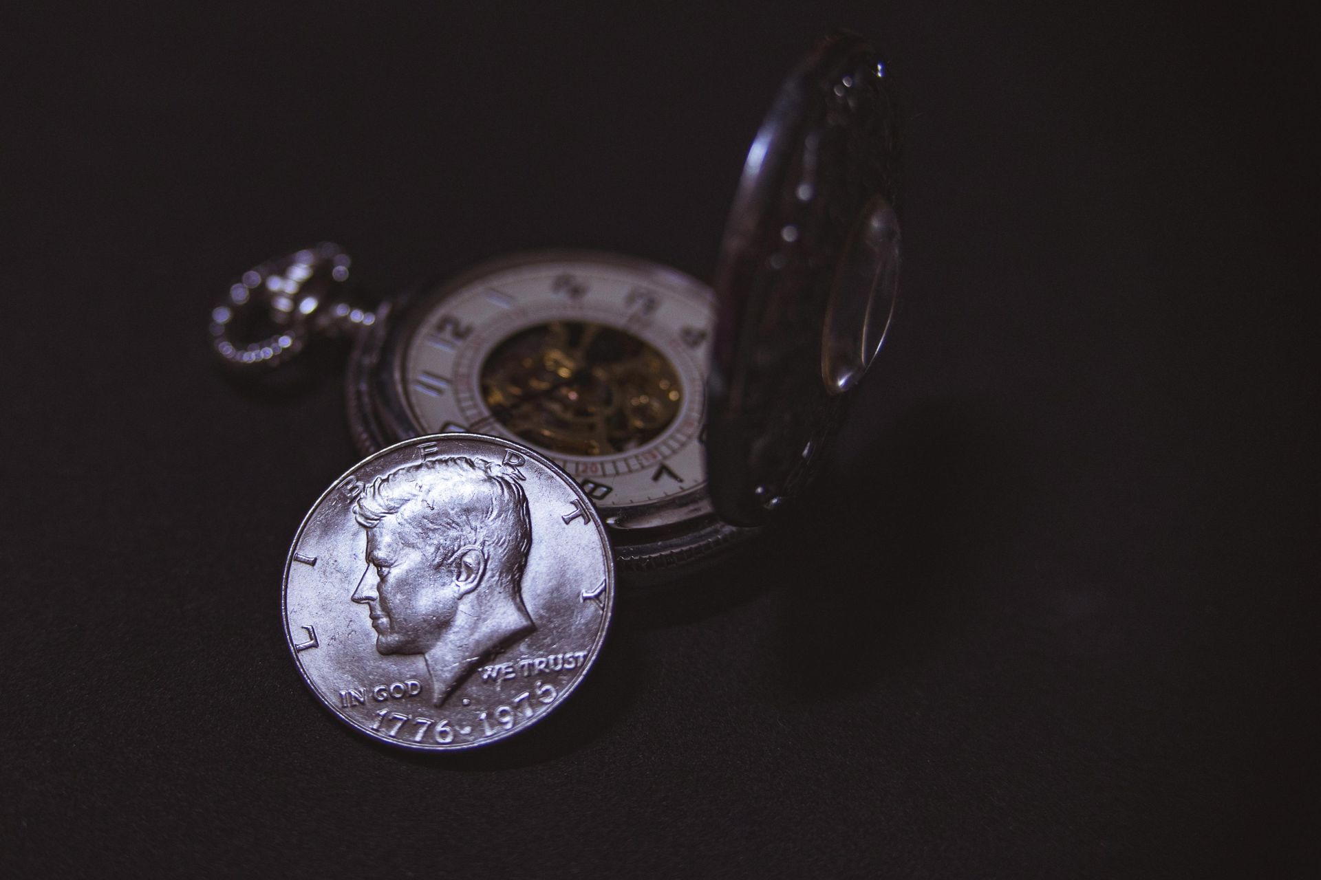 Picture of time piece and half dollar coin