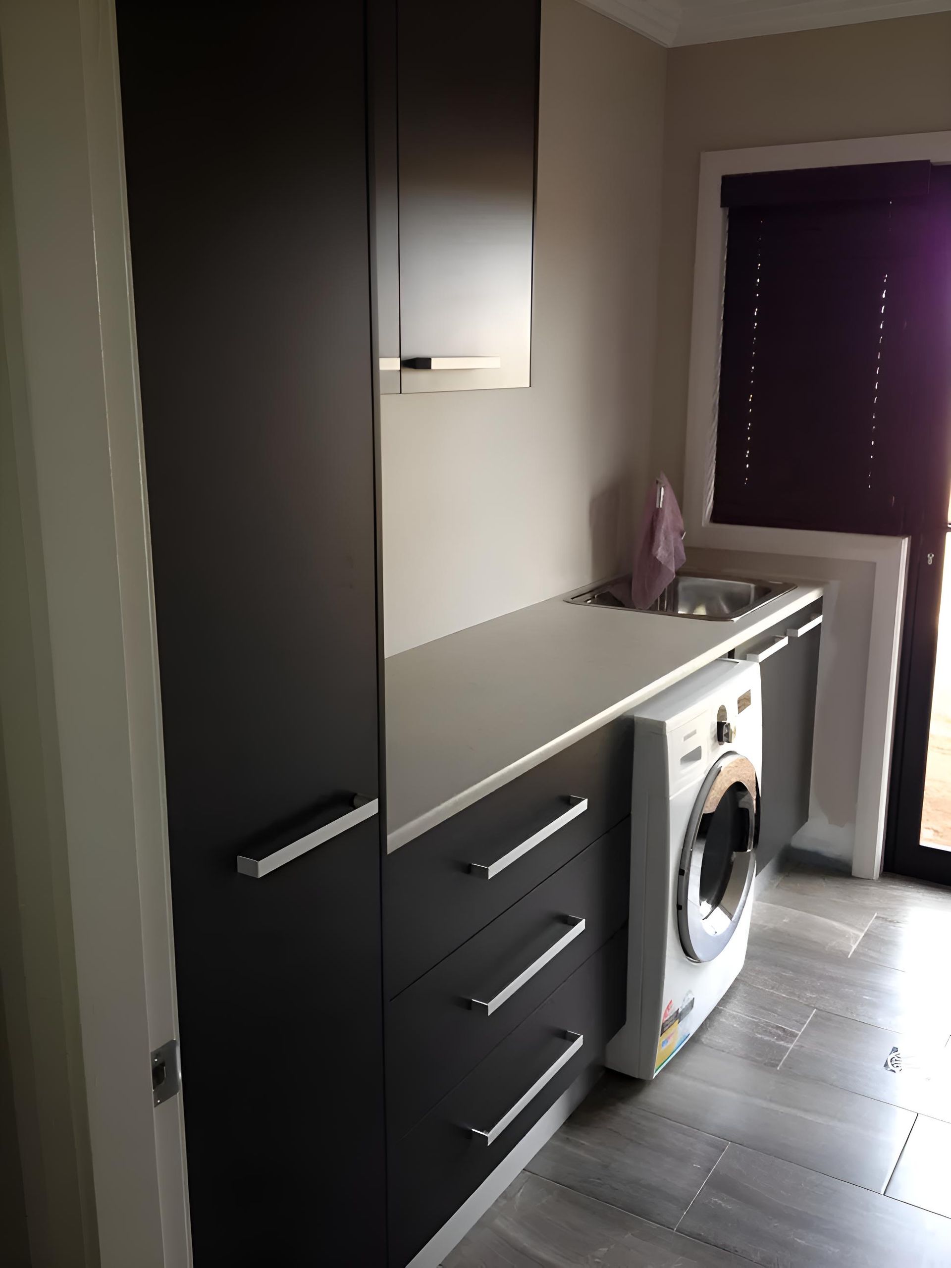 A kitchen with a washing machine and a sink — Hey Presto Kitchens & Renovations in Armidale, NSW