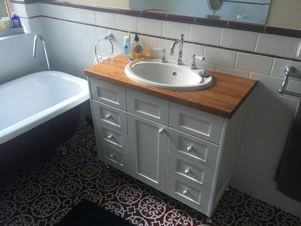 A Bathroom With a Bathtub and a Sink — Hey Presto Kitchens & Renovations in Armidale, NSW