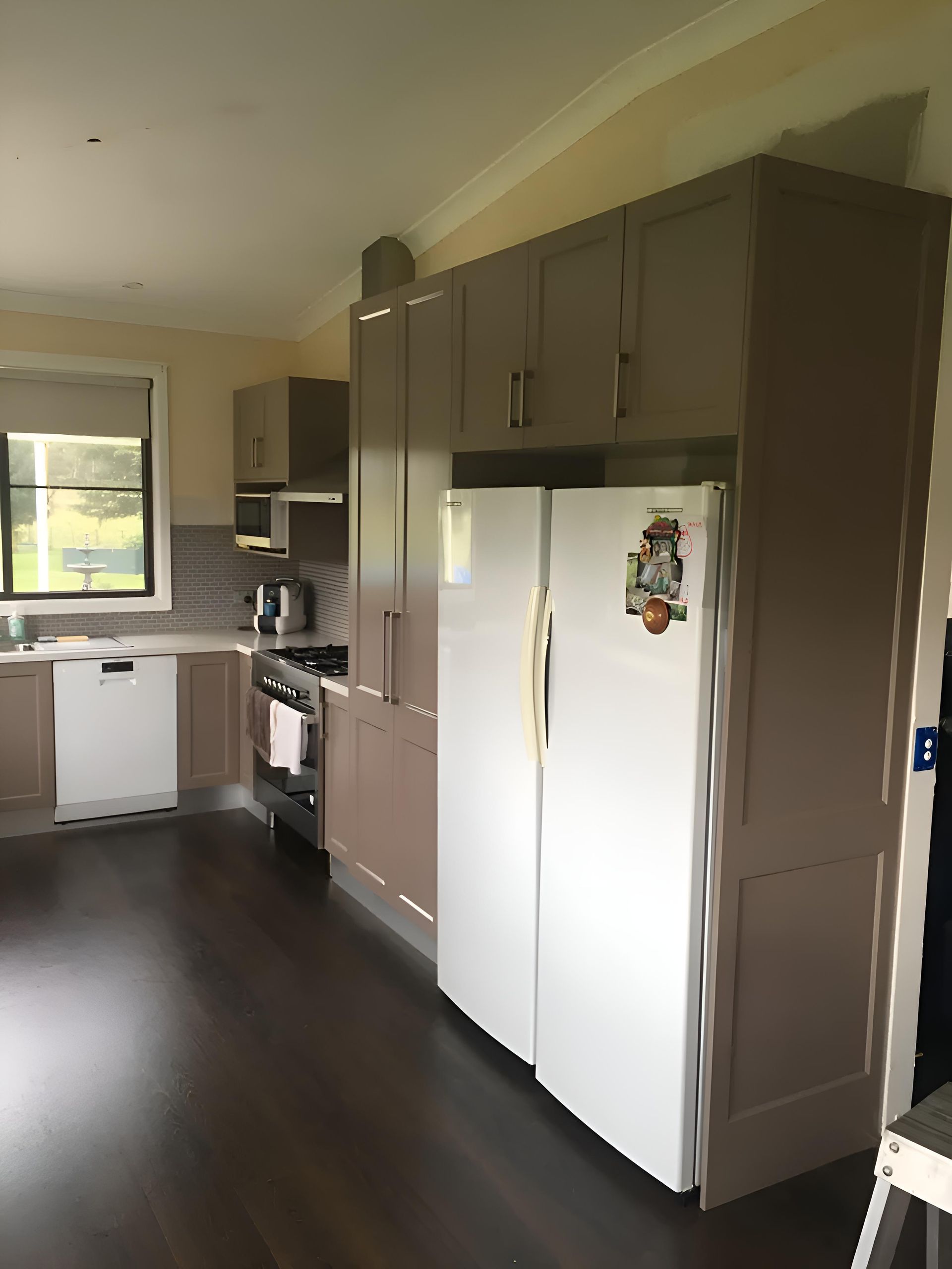 A Kitchen With Brown Cabinets And A White Refrigerator — Hey Presto Kitchens & Renovations in Armidale, NSW