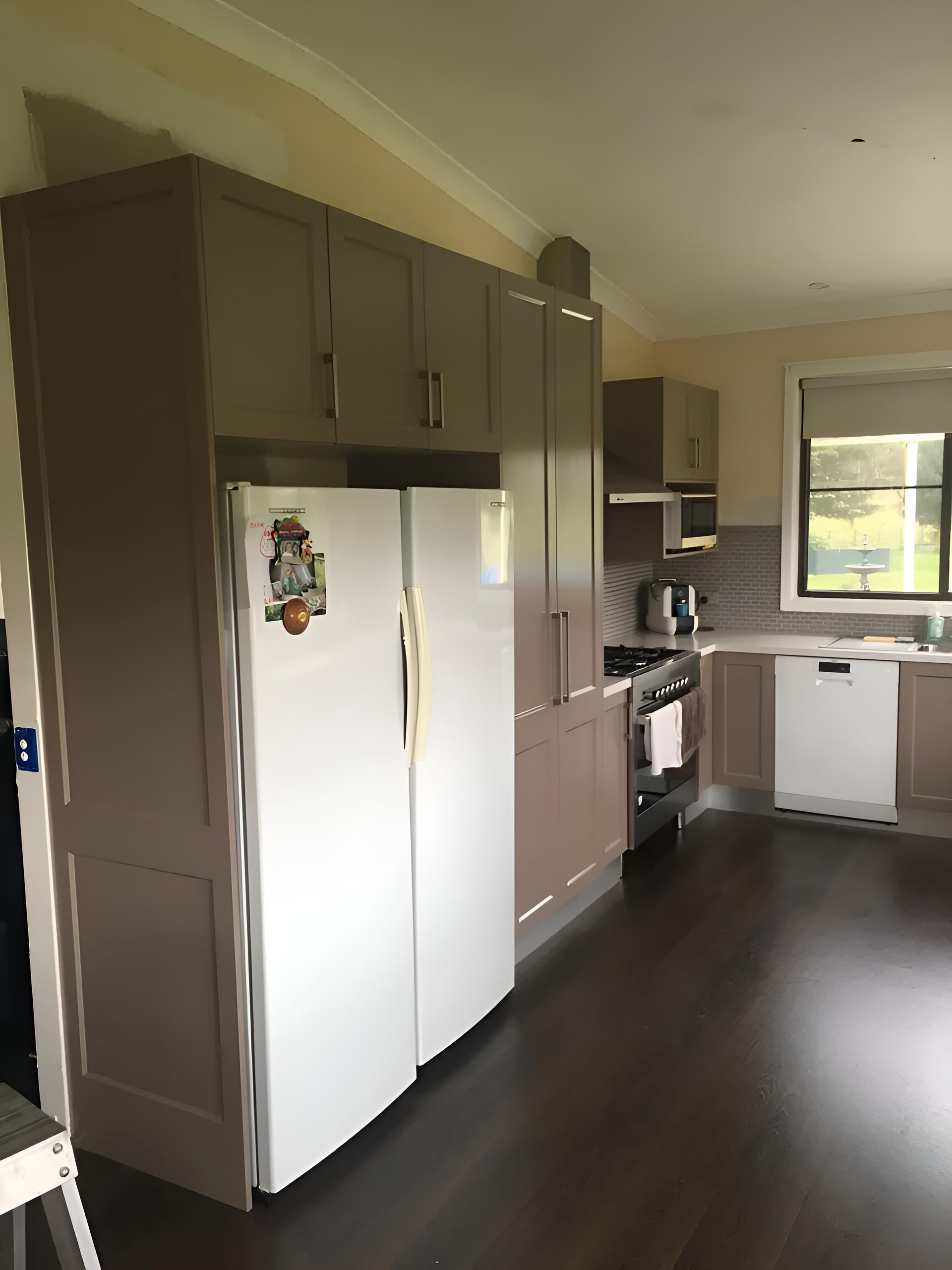 A Kitchen With Brown Cabinets And A White Refrigerator — Hey Presto Kitchens & Renovations in Armidale, NSW