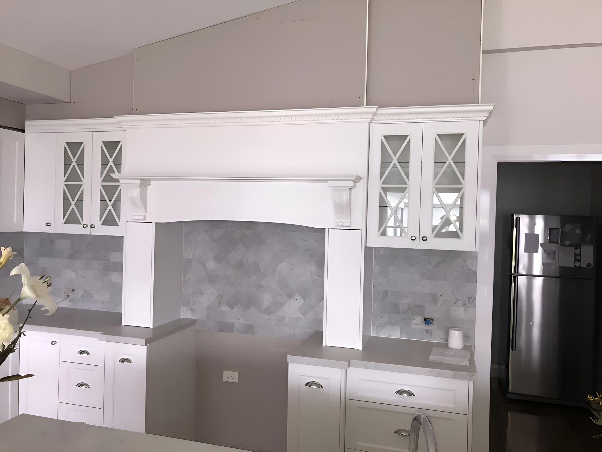A Kitchen With White Cabinets And A Stainless Steel Refrigerator — Hey Presto Kitchens & Renovations in Armidale, NSW
