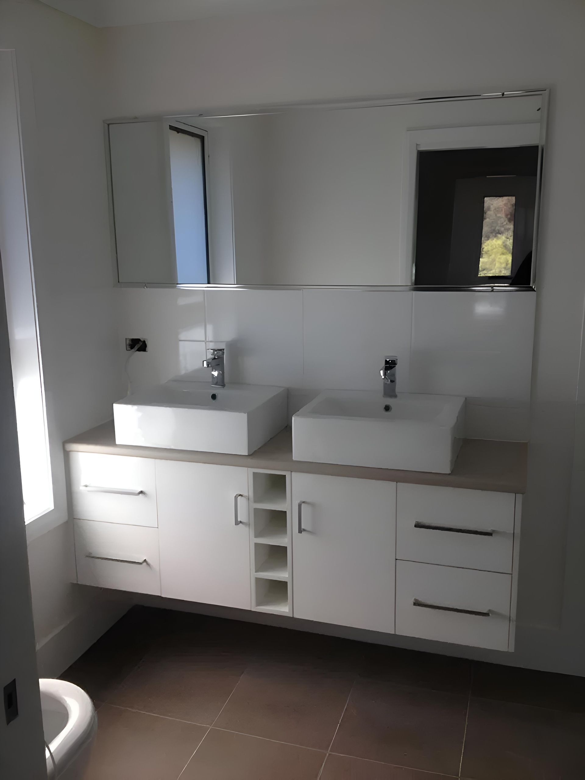 A Bathroom With Two Sinks And A Mirror — Hey Presto Kitchens & Renovations in Armidale, NSW