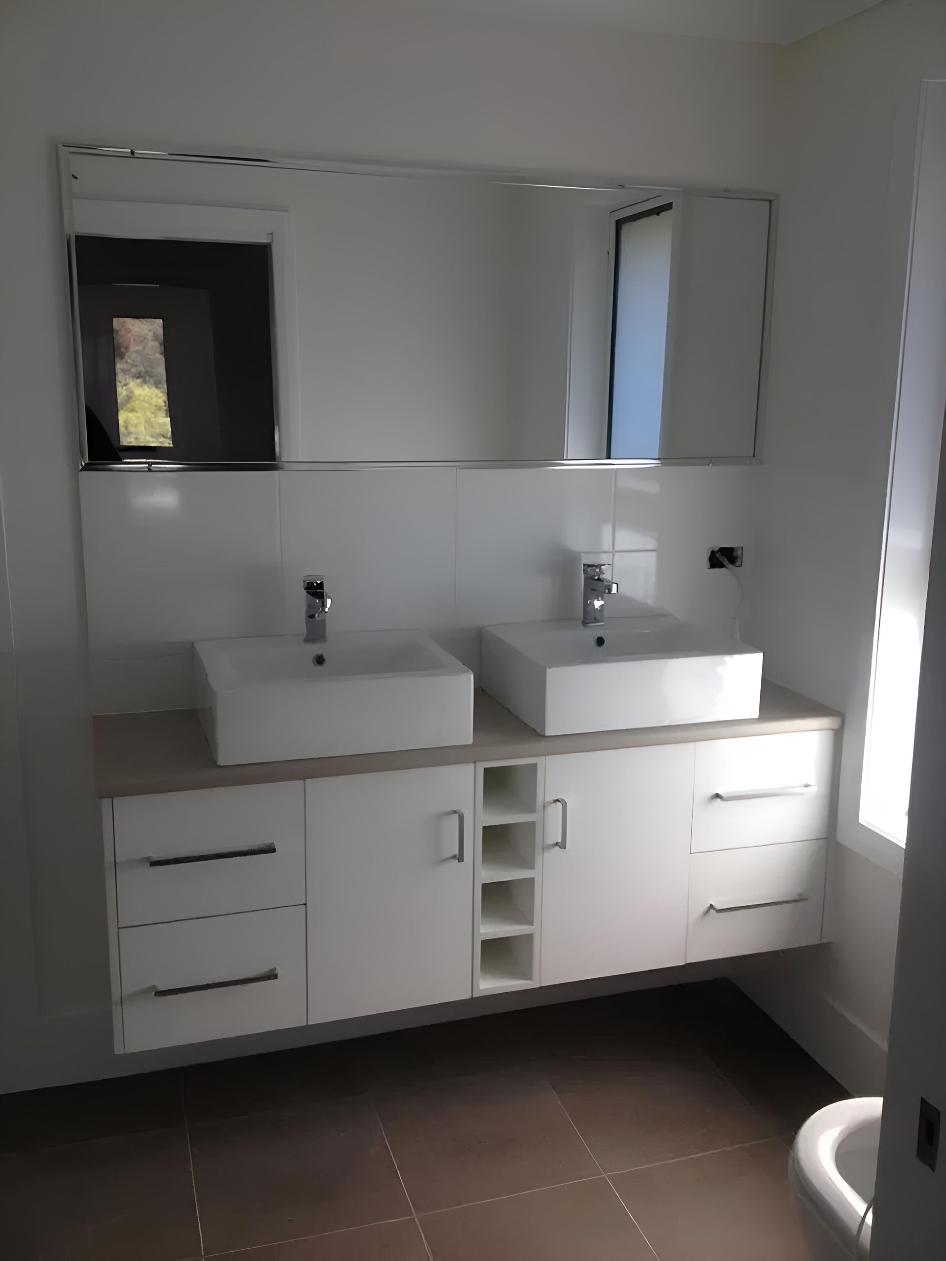 A Bathroom With Two Sinks And A Mirror — Hey Presto Kitchens & Renovations in Guyra, NSW
