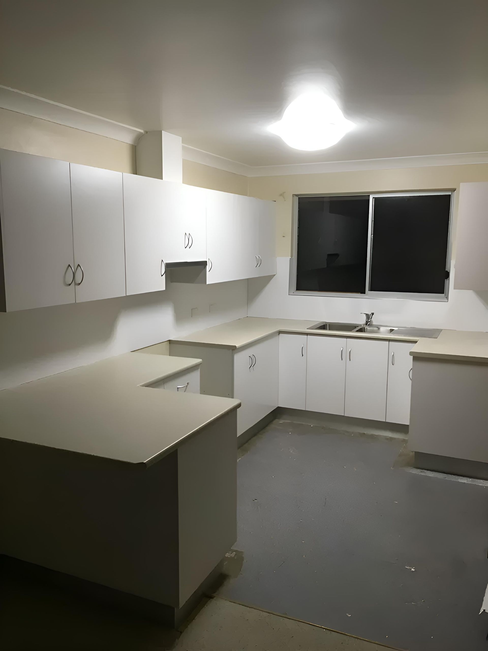 A Kitchen With White Cabinets , A Sink , And A Window — Hey Presto Kitchens & Renovations in Armidale, NSW