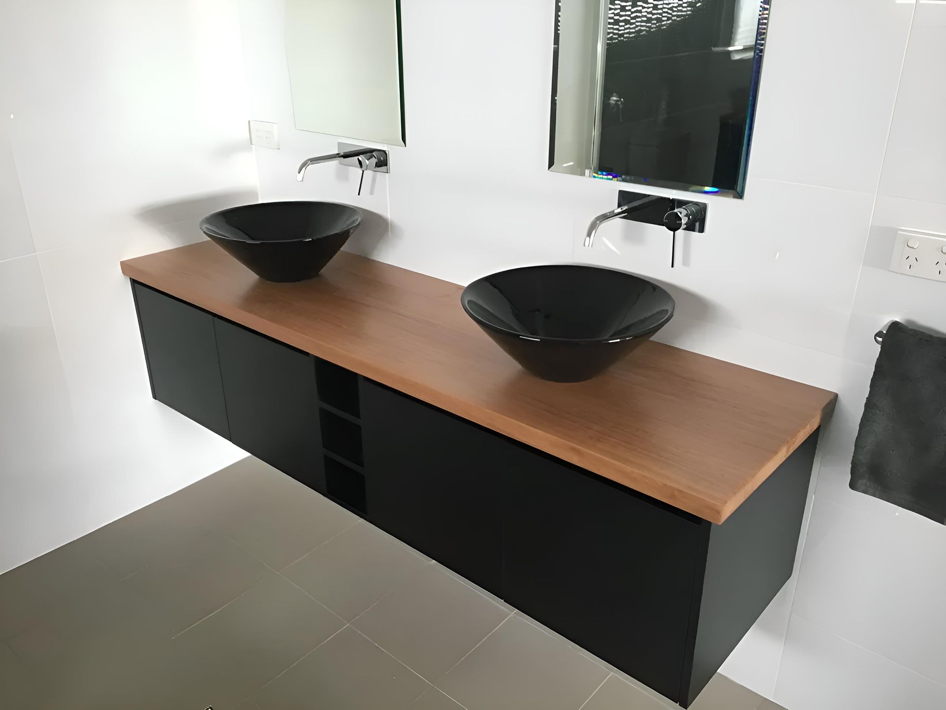 A Bathroom With Two Black Sinks And  Mirrors — Hey Presto Kitchens & Renovations in Armidale, NSW