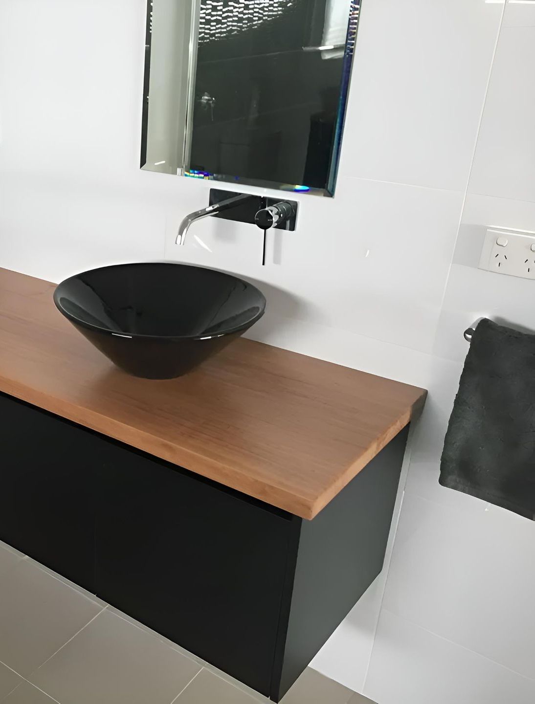 A Bathroom With A Black Sink And A Mirror — Hey Presto Kitchens & Renovations in Armidale, NSW
