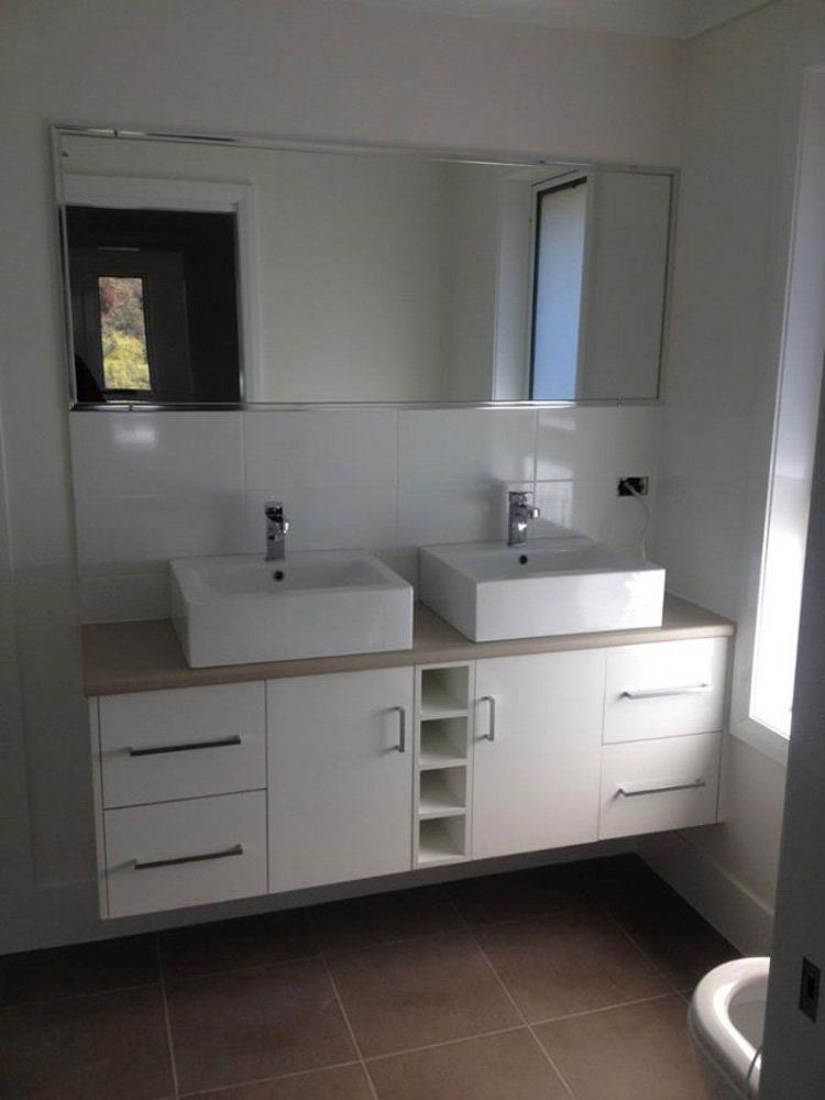 A Bathroom With Two Sinks and a Toilet — Hey Presto Kitchens & Renovations in Armidale, NSW