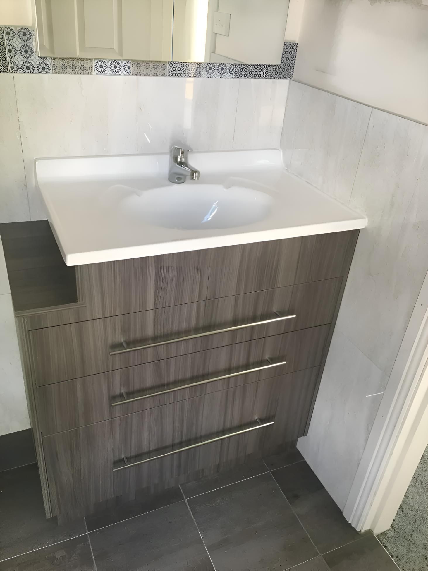 A Bathroom Vanity With A Sink And A Mirror — Hey Presto Kitchens & Renovations in Armidale, NSW