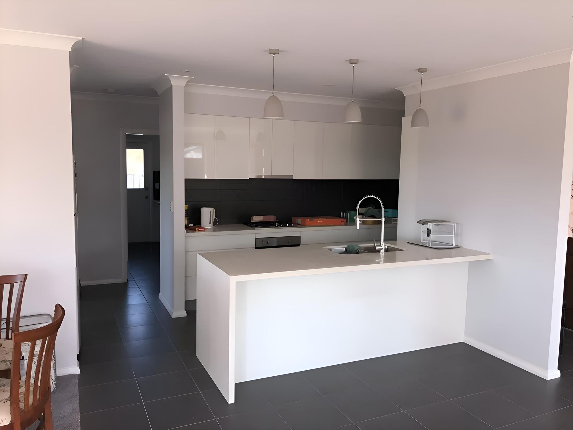 A Kitchen With White Cabinets And A Large Island — Hey Presto Kitchens & Renovations in Armidale, NSW
