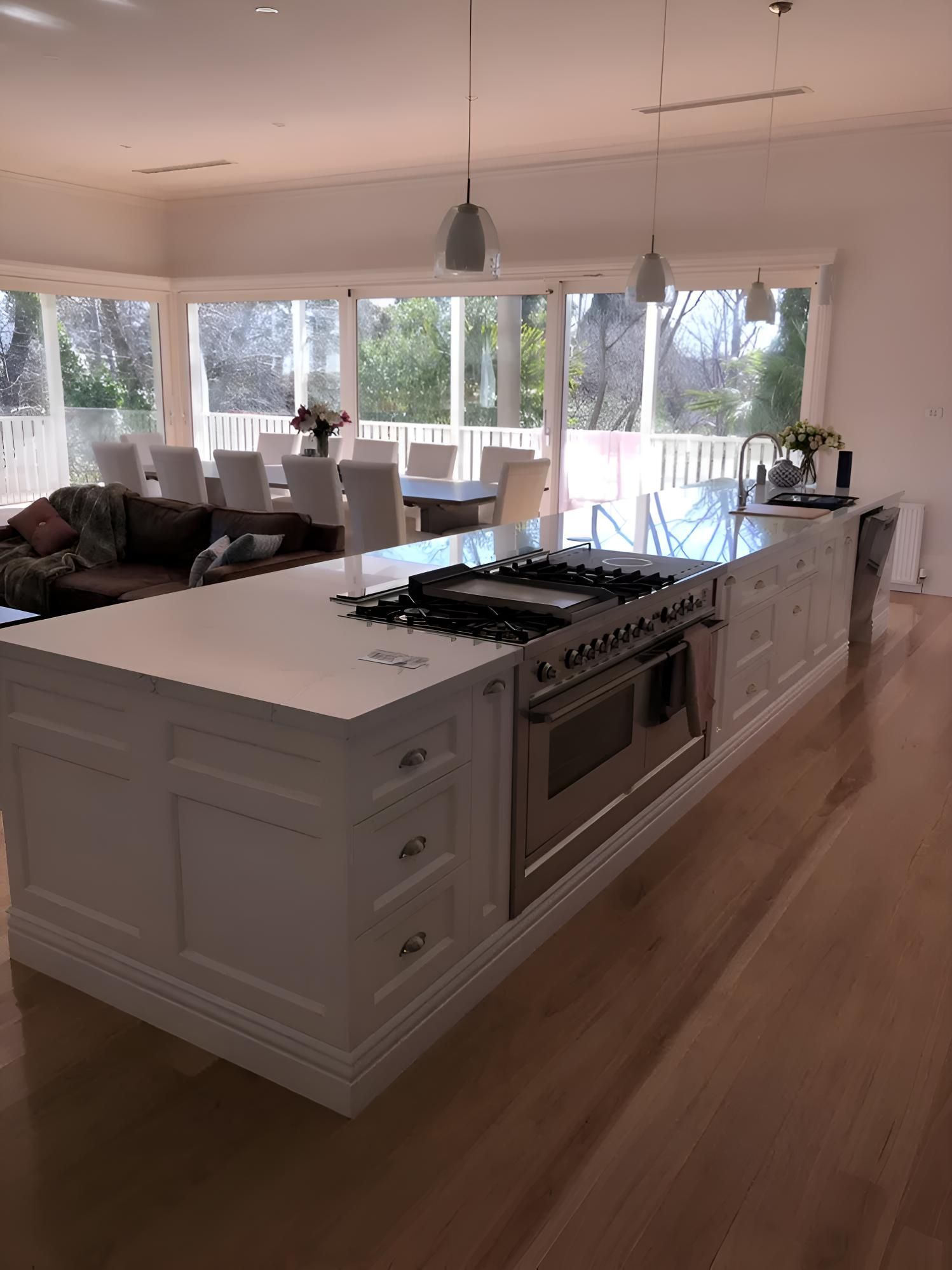 A Kitchen With A Large Island And Stove Top Oven — Hey Presto Kitchens & Renovations in Uralla, NSW