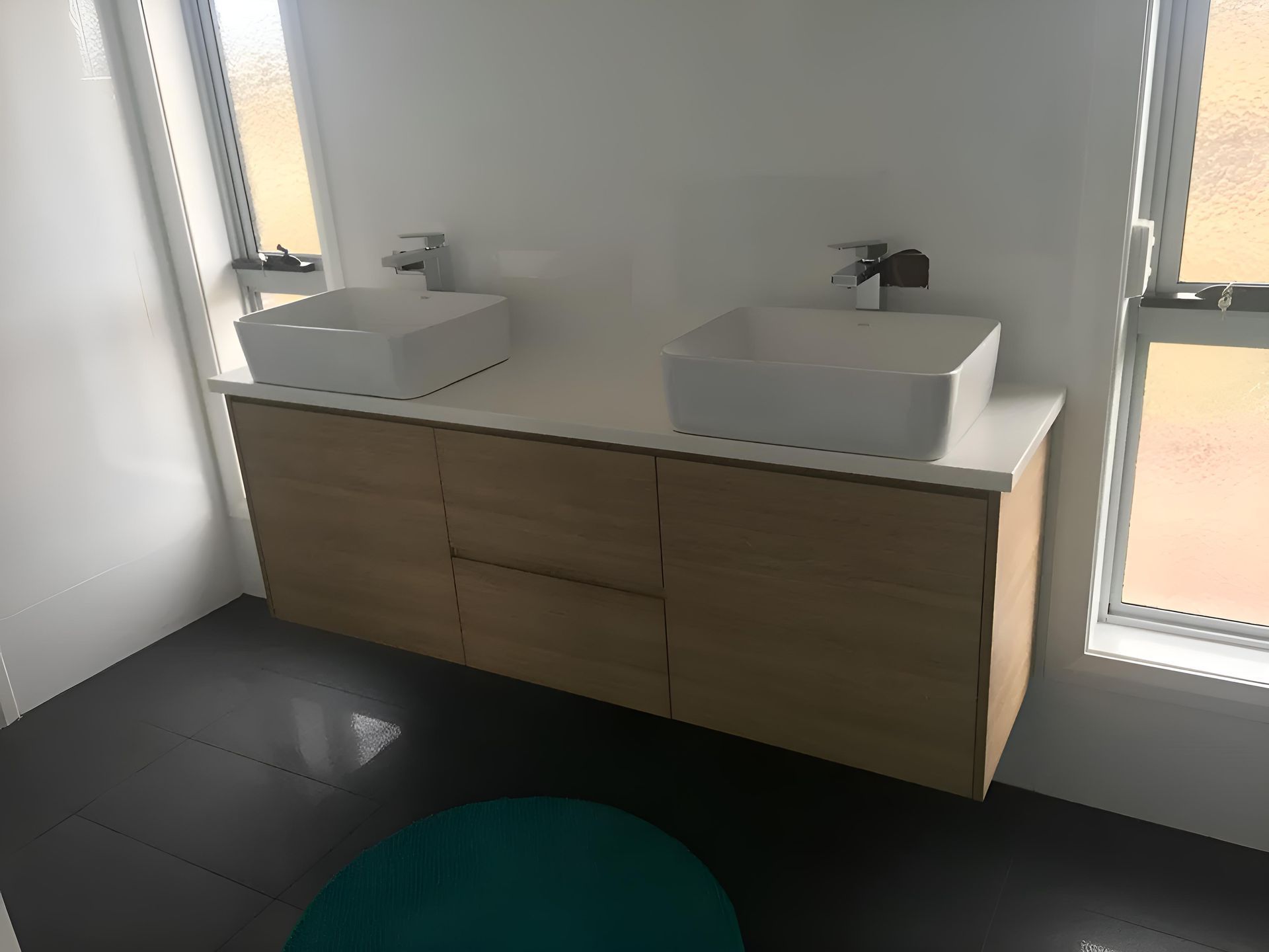 A Bathroom With Two Sinks And A Window — Hey Presto Kitchens & Renovations in Armidale, NSW
