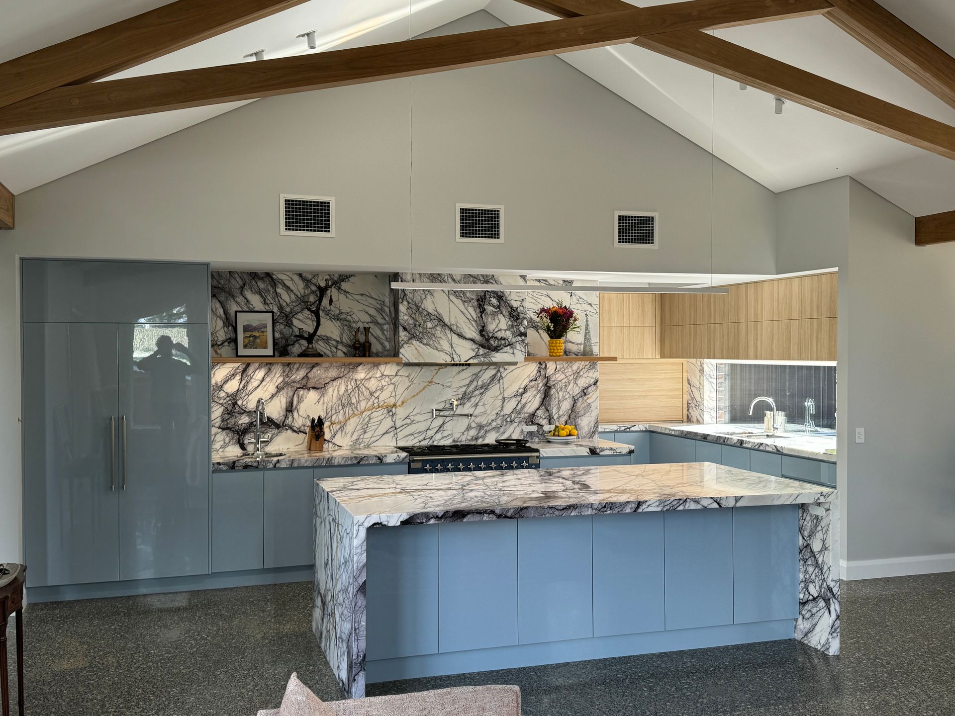 A Kitchen With Blue Cabinets and Marble Counter Tops — Hey Presto Kitchens & Renovations in Armidale, NSW