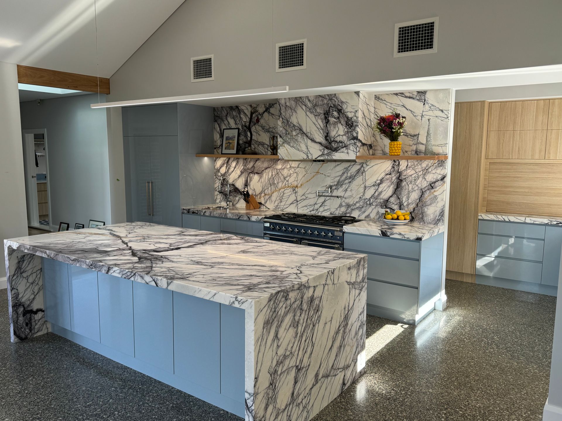 A Kitchen With a Large Island and Marble Counter Tops — Hey Presto Kitchens & Renovations in Armidale, NSW