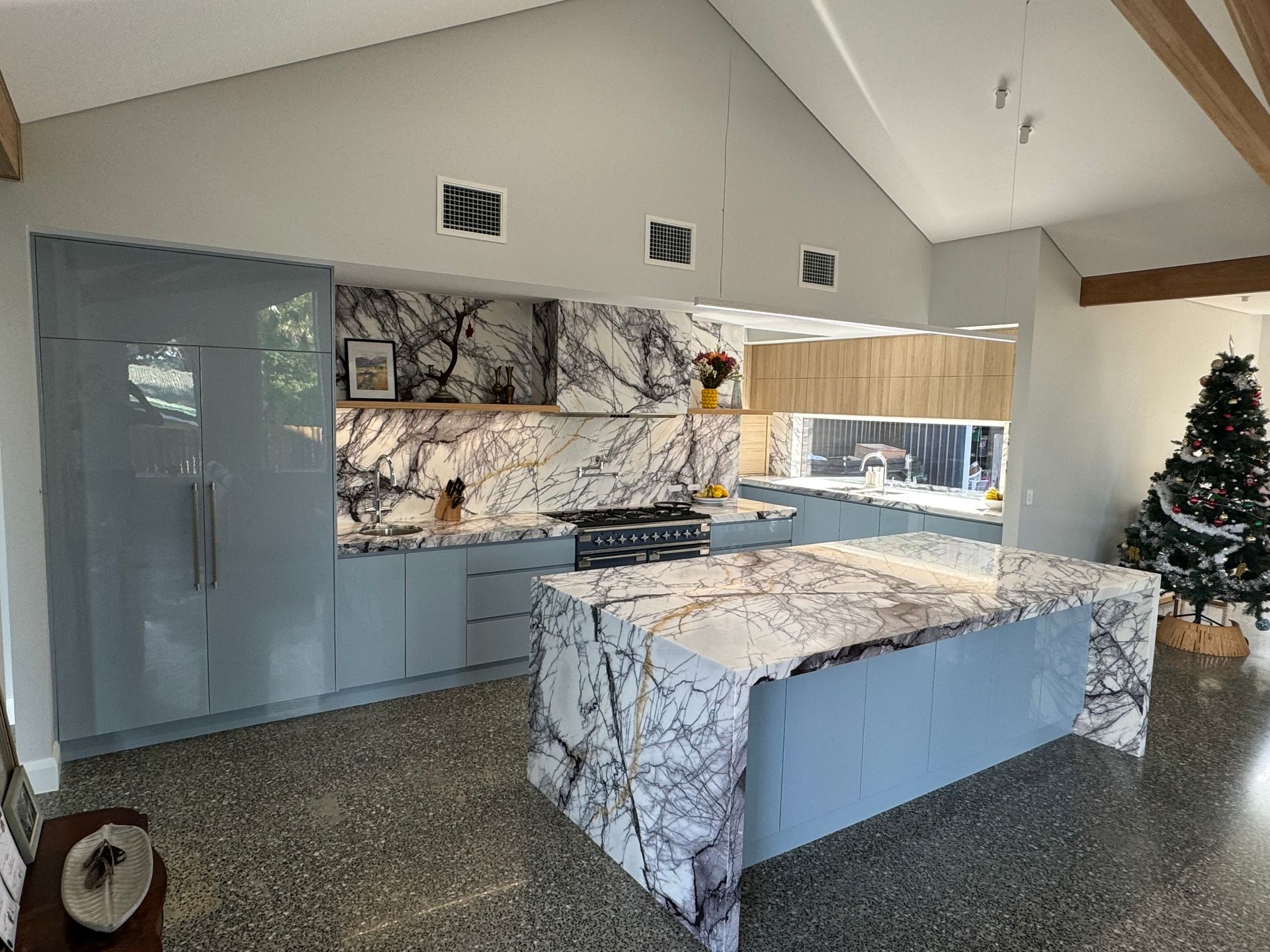 A Kitchen With a Large Island and a Christmas Tree in the Background — Hey Presto Kitchens & Renovations in Armidale, NSW