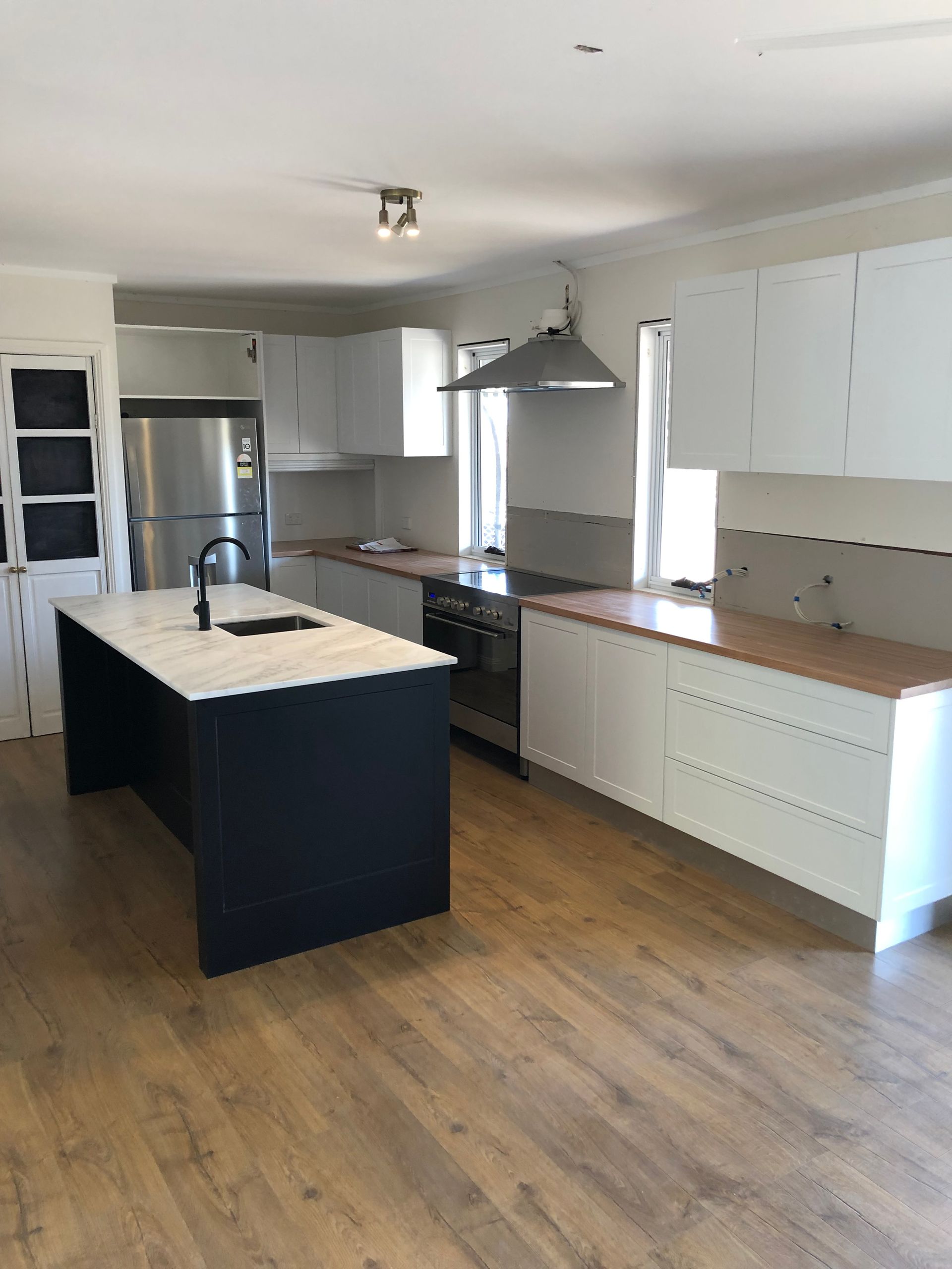 A Kitchen With a Large Island in the Middle of the Room — Hey Presto Kitchens & Renovations in Armidale, NSW