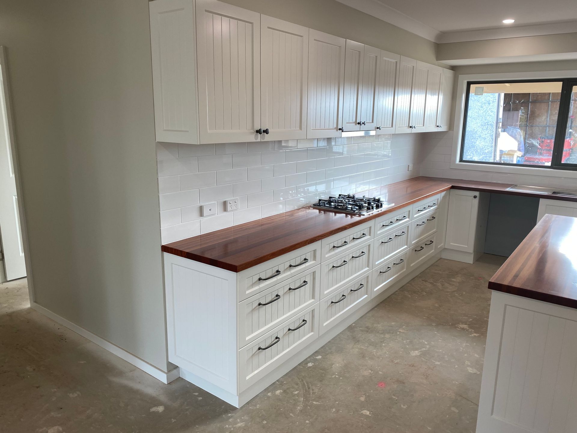 A Kitchen With White Cabinets and Wooden Counter Tops — Hey Presto Kitchens & Renovations in Armidale, NSW