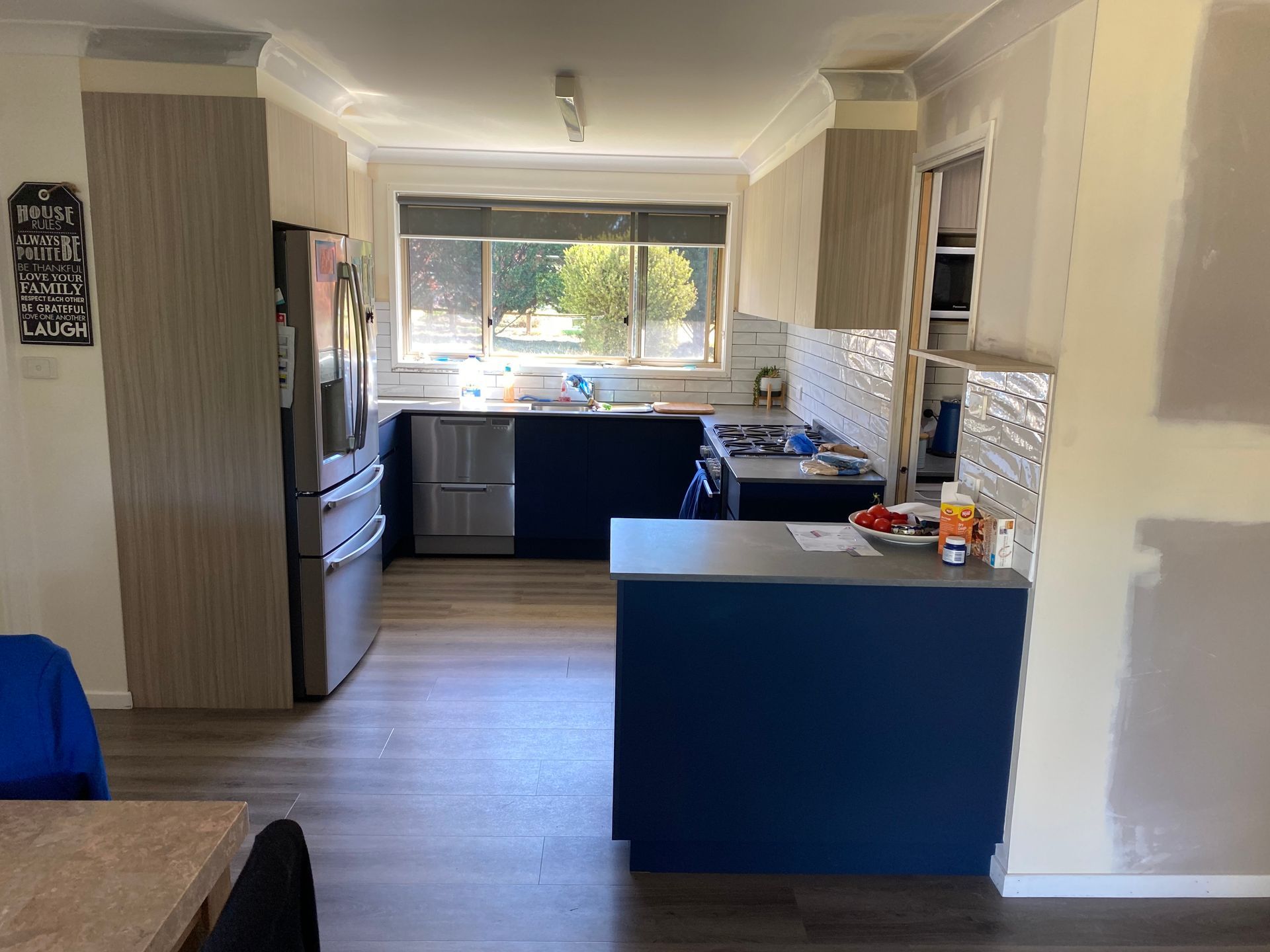 A Kitchen With Blue Cabinets and a Blue Island in the Middle of the Room — Hey Presto Kitchens & Renovations in Armidale, NSW