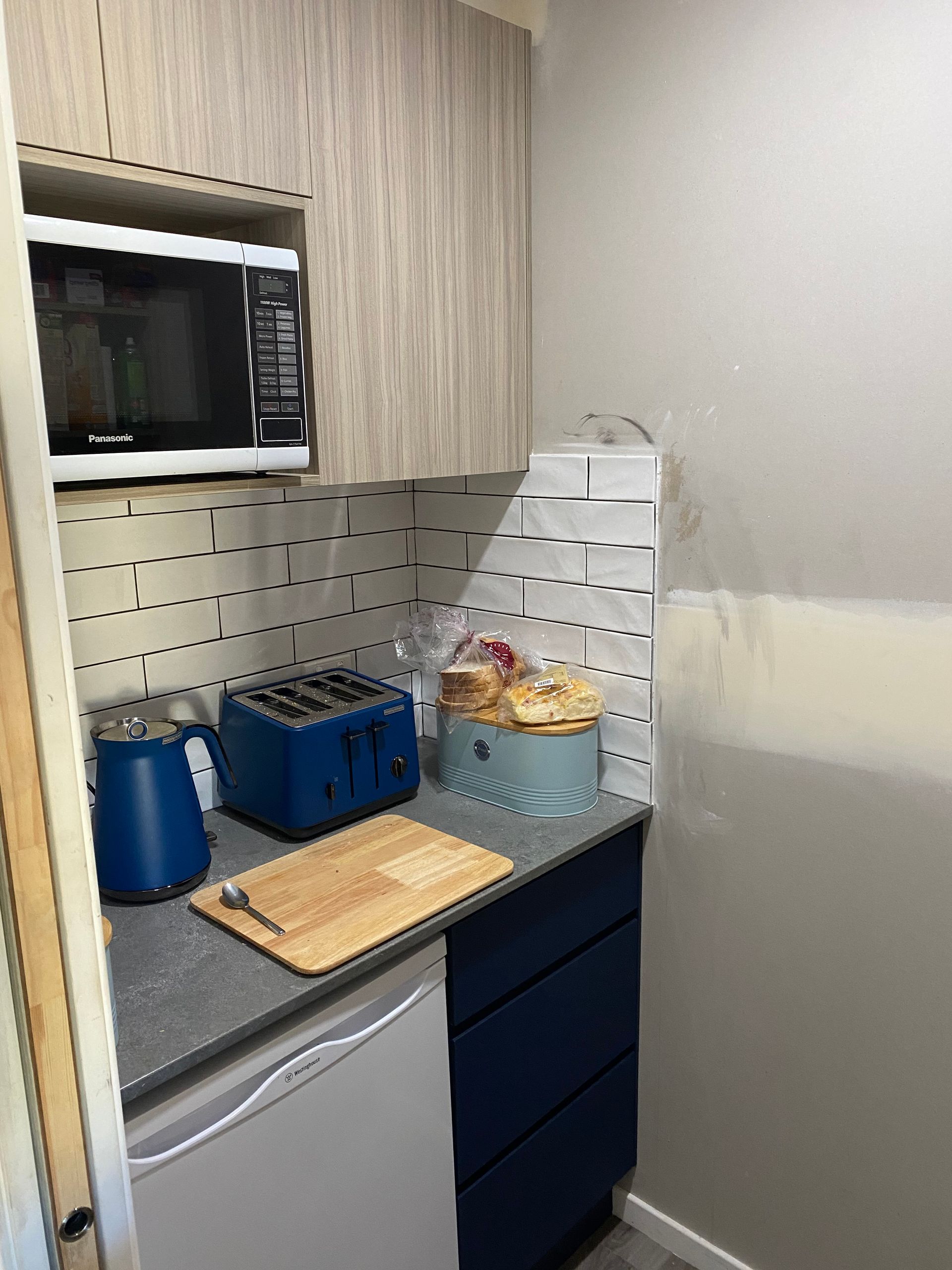 A Kitchen With a Microwave, Toaster, and Cutting Board — Hey Presto Kitchens & Renovations in Armidale, NSW