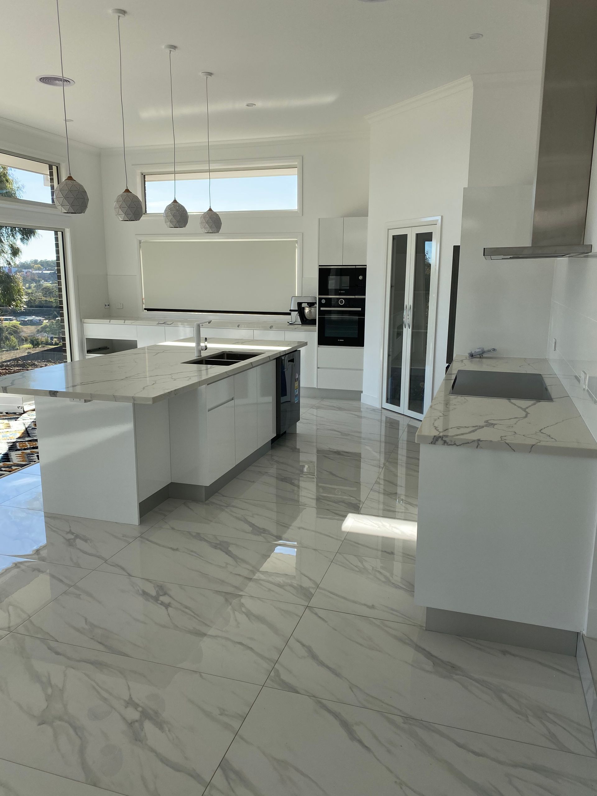 A Kitchen With White Cabinets and Granite Counter Tops — Hey Presto Kitchens & Renovations in Armidale, NSW