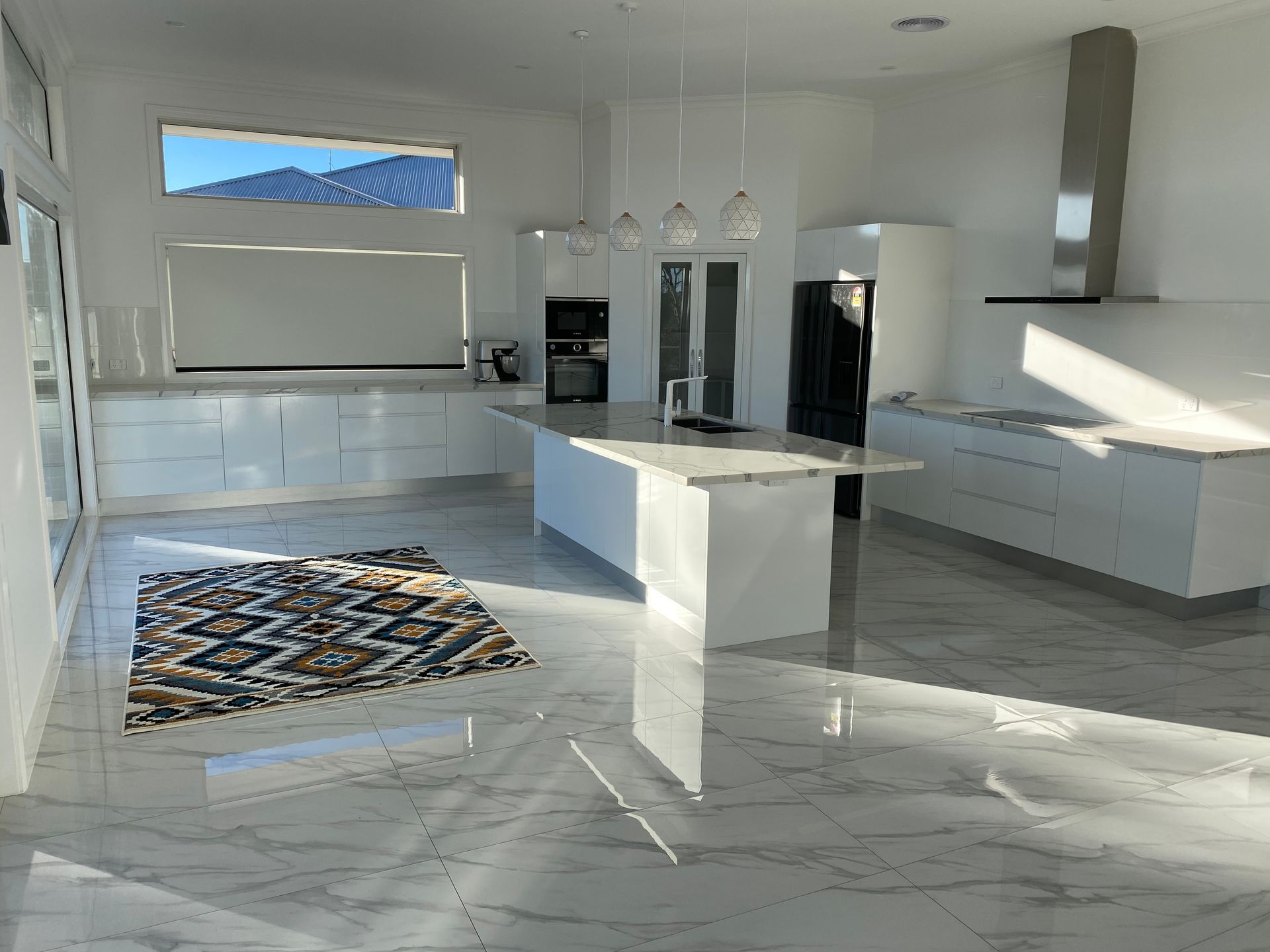 A Kitchen With White Cabinets and a Rug on the Floor — Hey Presto Kitchens & Renovations in Armidale, NSW