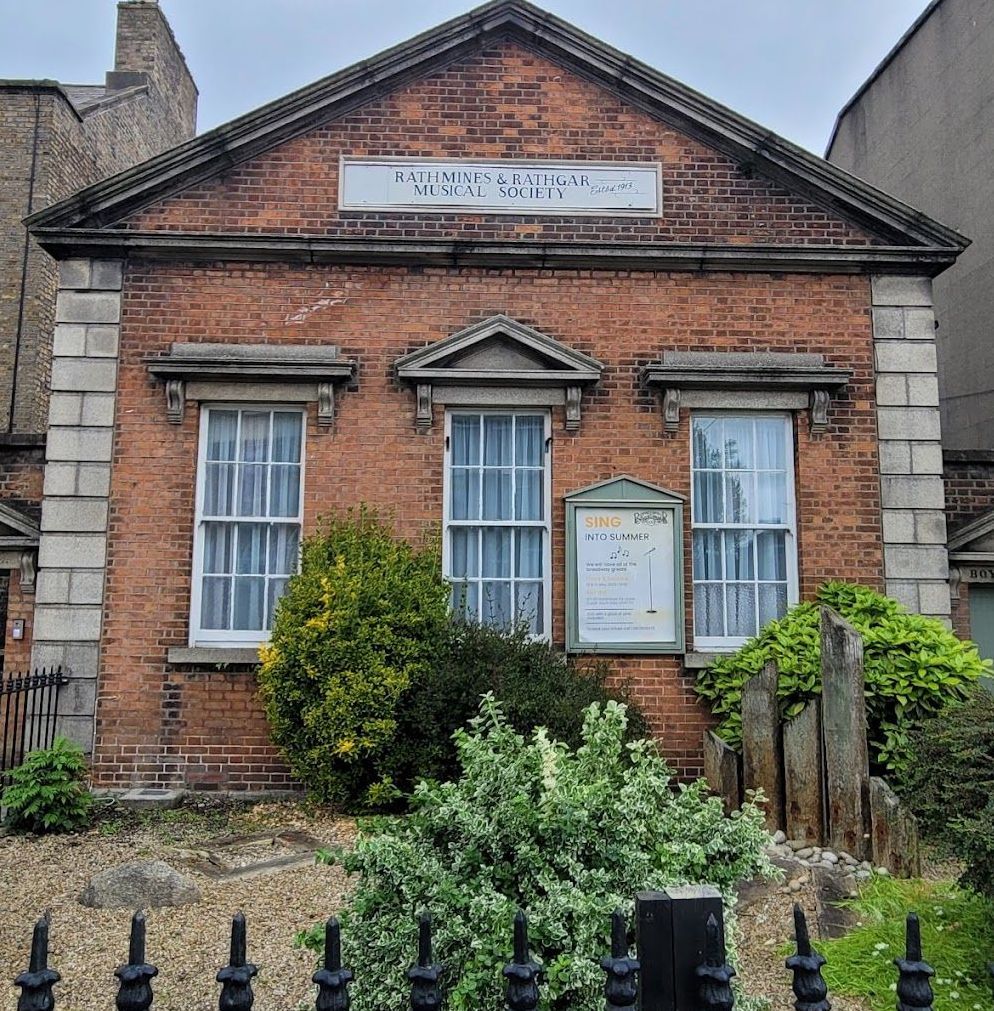 A brick building with a sign on it that says ' women 's national society '