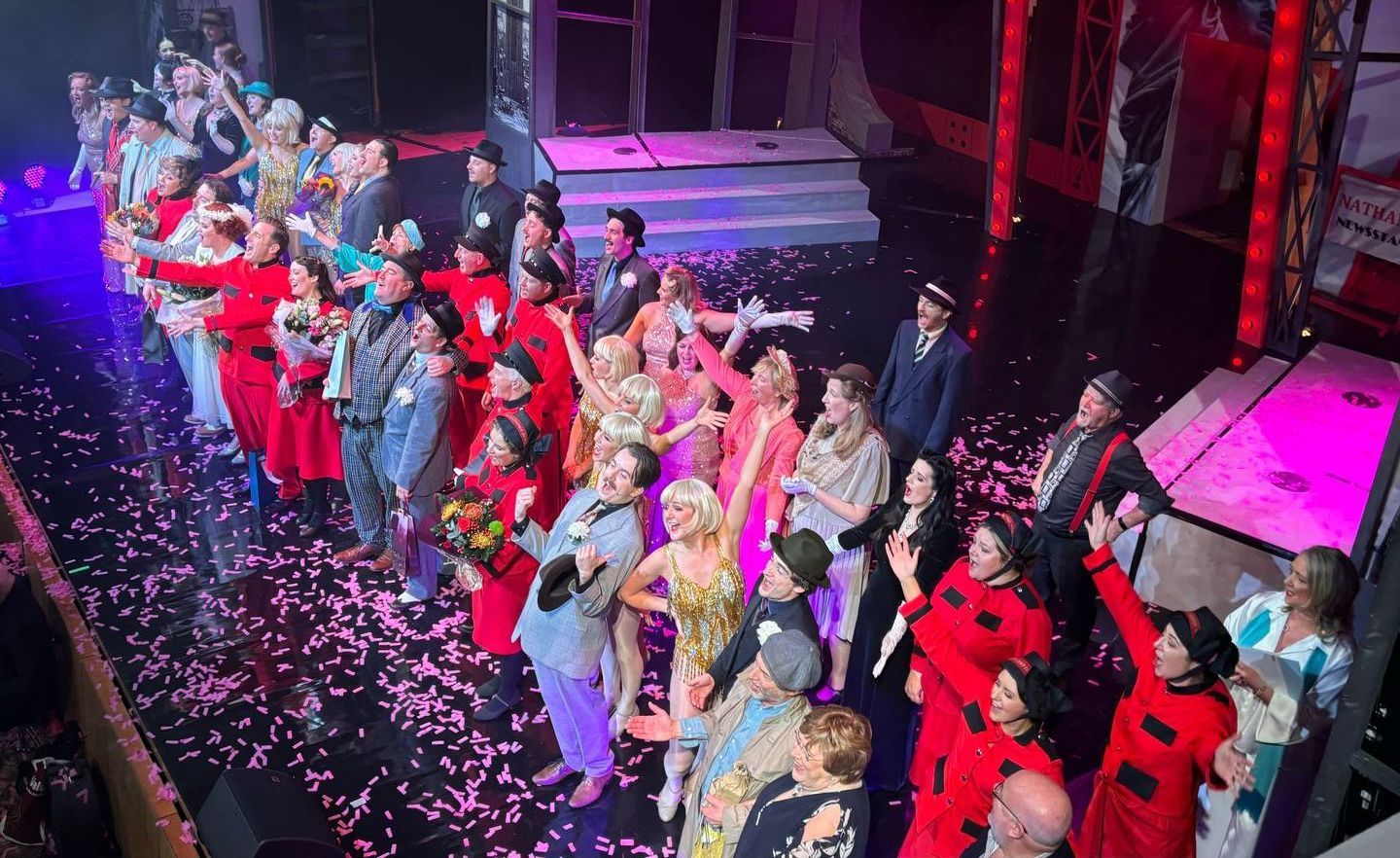 A large group of people are standing on a stage.