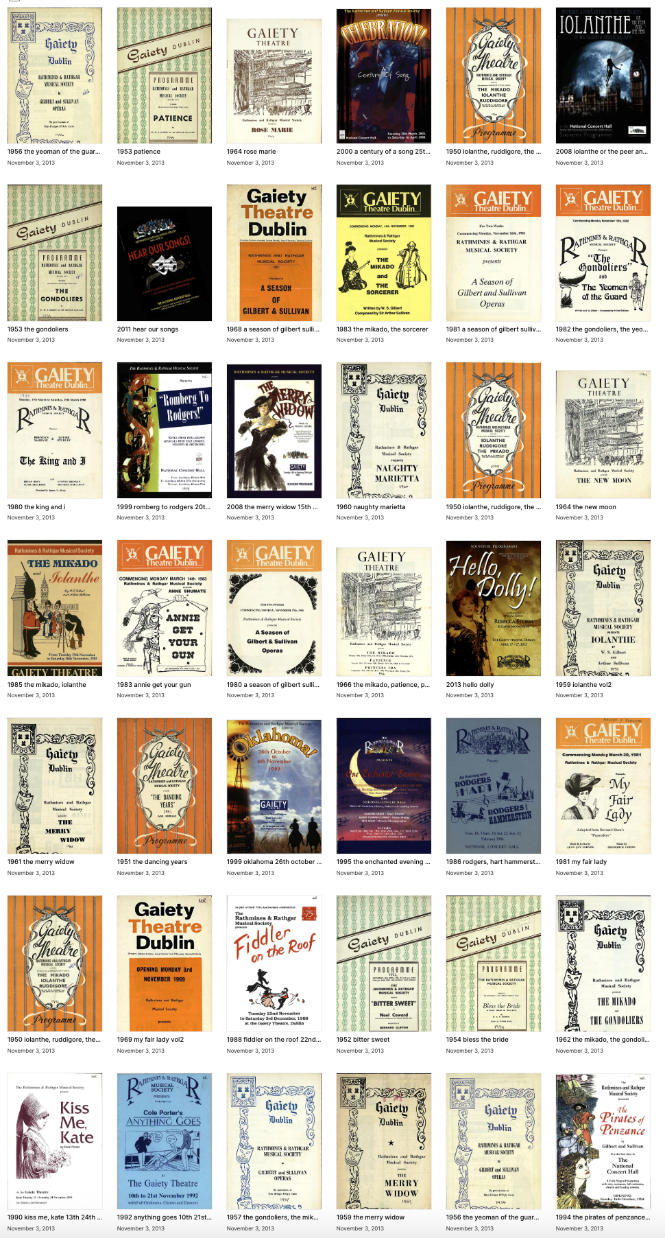 A bunch of books are lined up on a table.