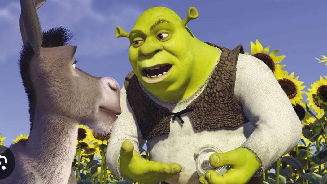 Shrek is talking to a donkey in a field of sunflowers.