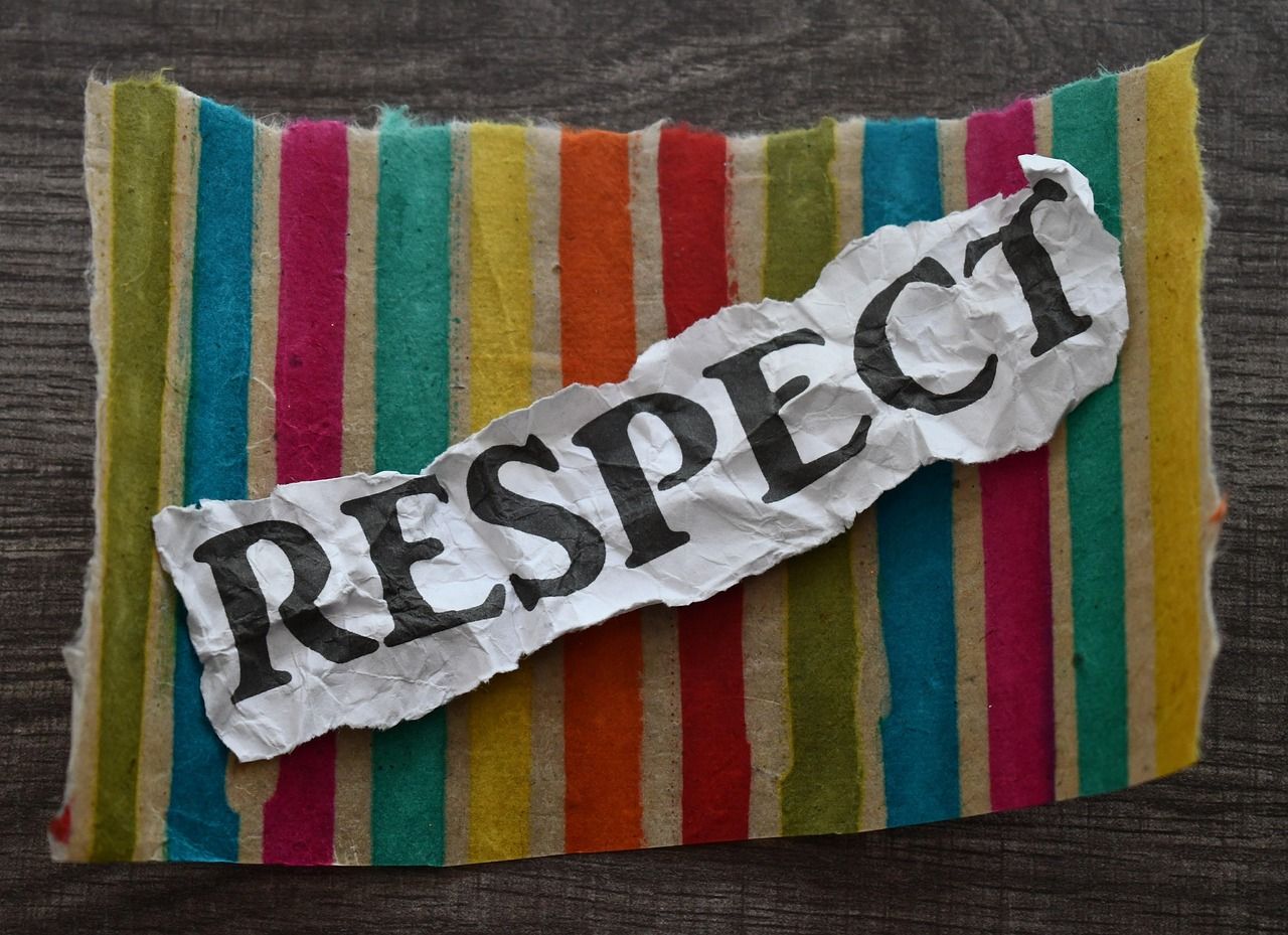 A piece of torn paper with the word respect written on it