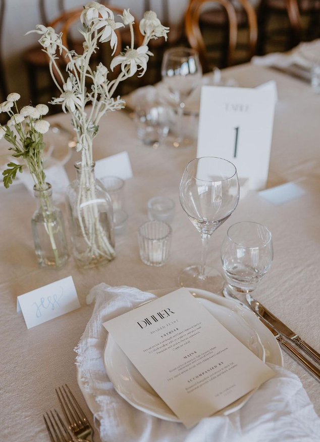 A Table Set For A Wedding Reception With Plates, Glasses, And Flowers — Wedding & Event Hire In Goonellabah, NSW