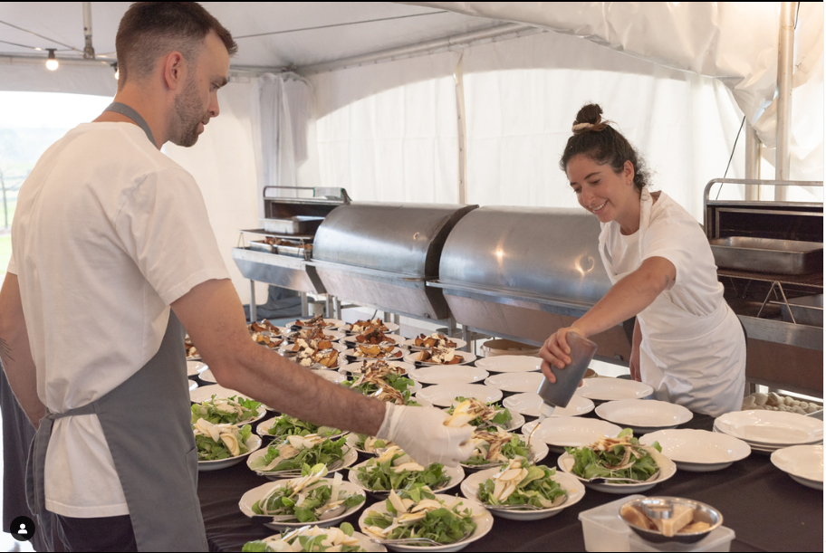 A Man And A Woman Are Preparing Food In A Tent — Wedding & Event Hire In Bangalow, NSW