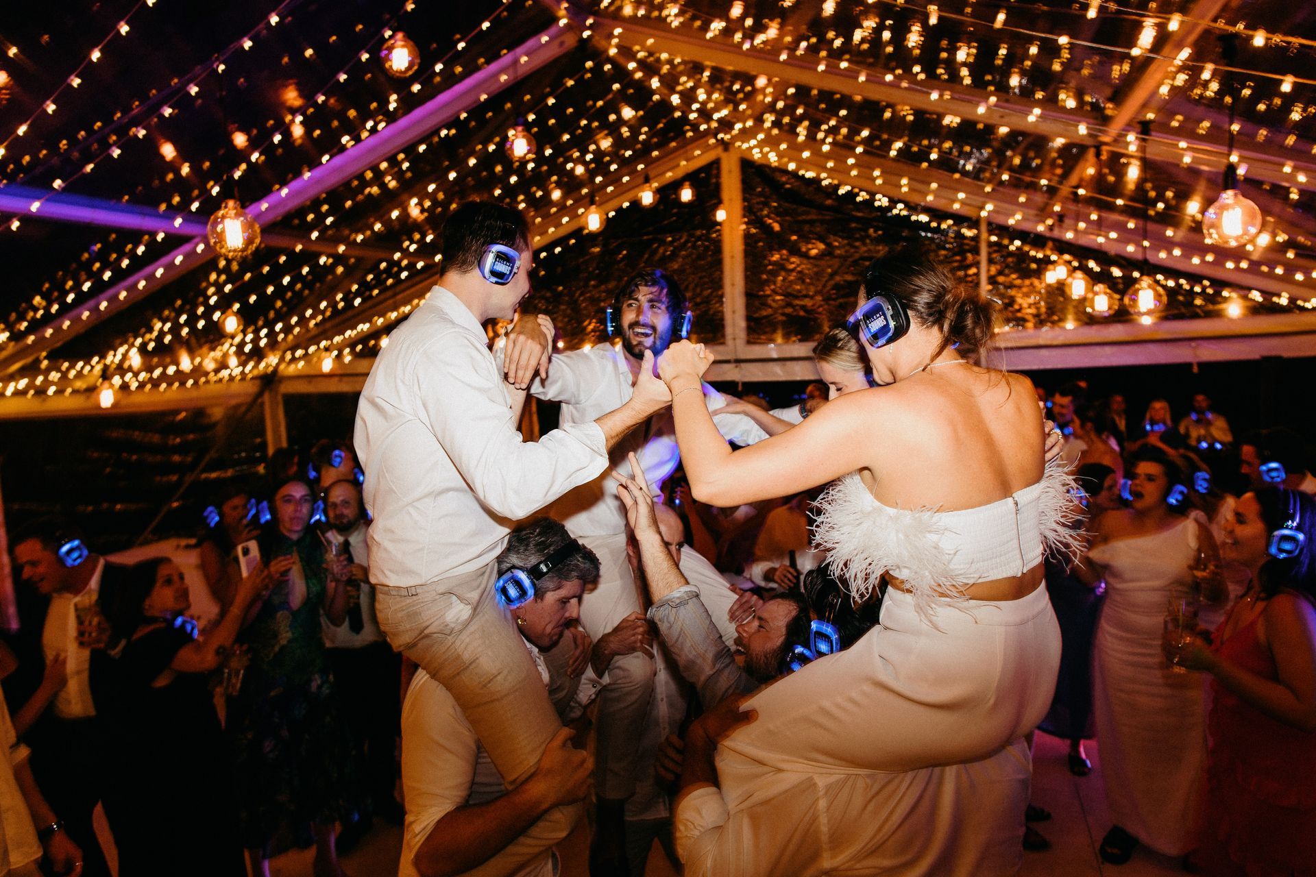 A Bride And Groom Are Dancing At A Wedding Reception While Wearing Headphones — Wedding & Event Hire In Bangalow, NSW