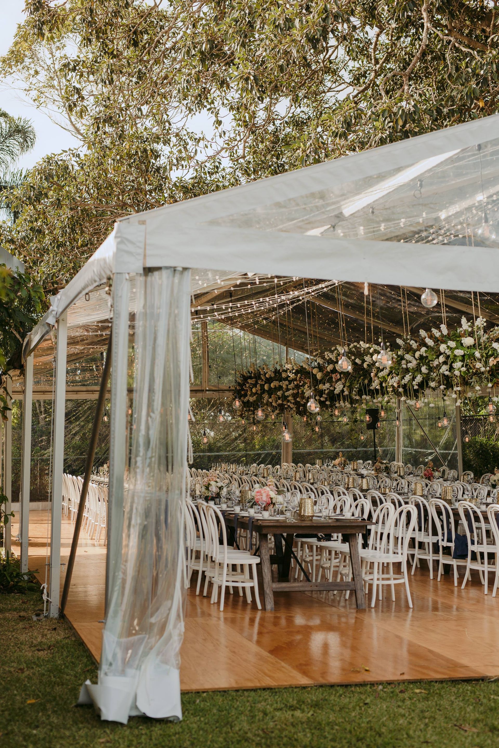 A Clear Tent With Tables And Chairs Underneath It — Wedding & Event Hire In Goonellabah, NSW